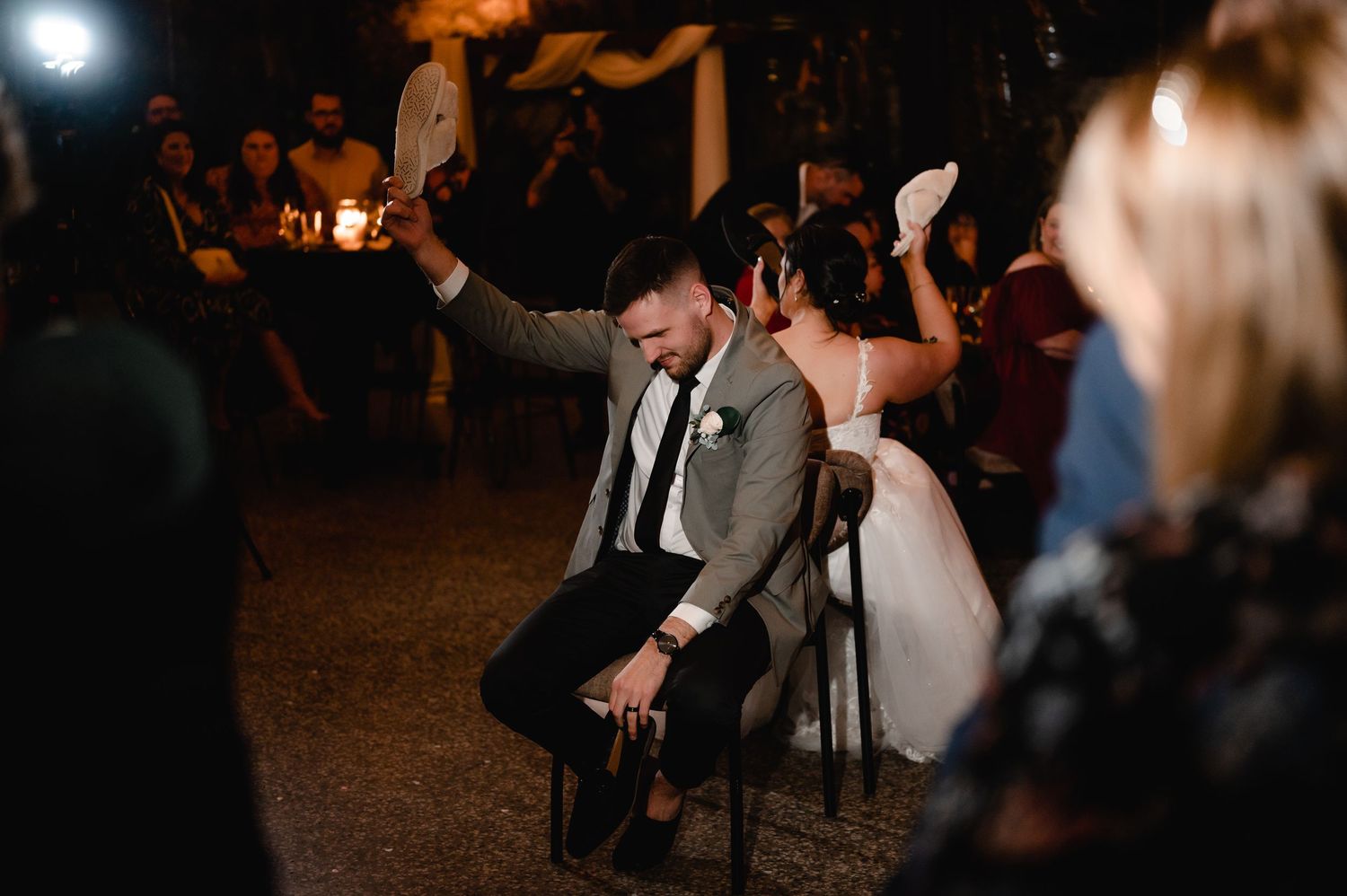Lively dance floor scene with guests celebrating at a nighttime wedding reception.