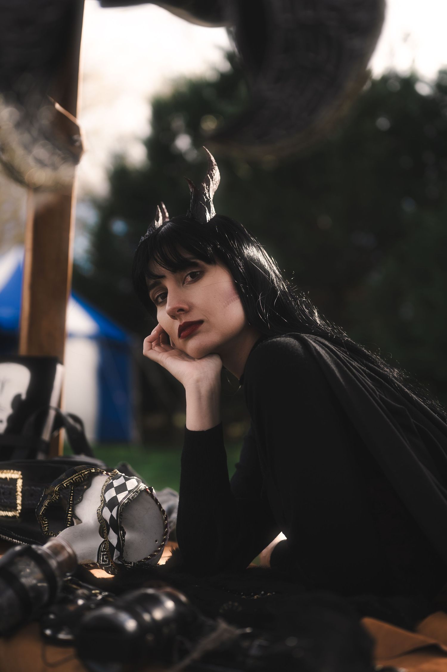 Moody portrait photography with natural window lighting and camera equipment.