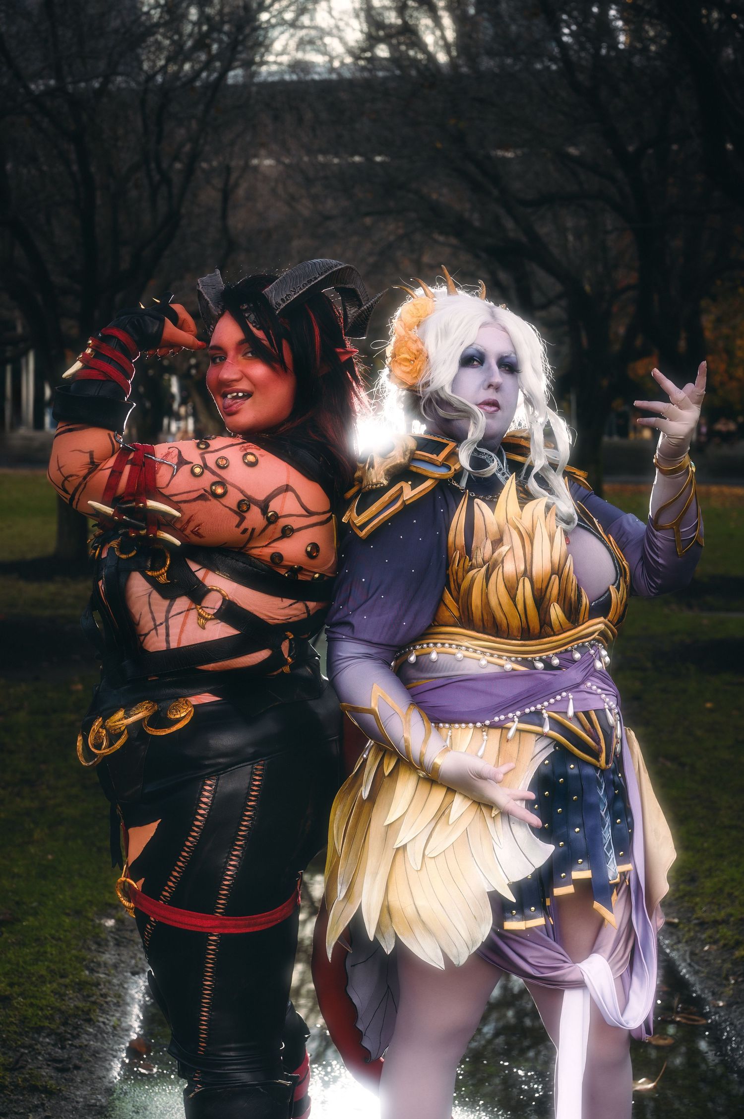 Fantasy cosplay scene with characters in elaborate costumes interacting outdoors.