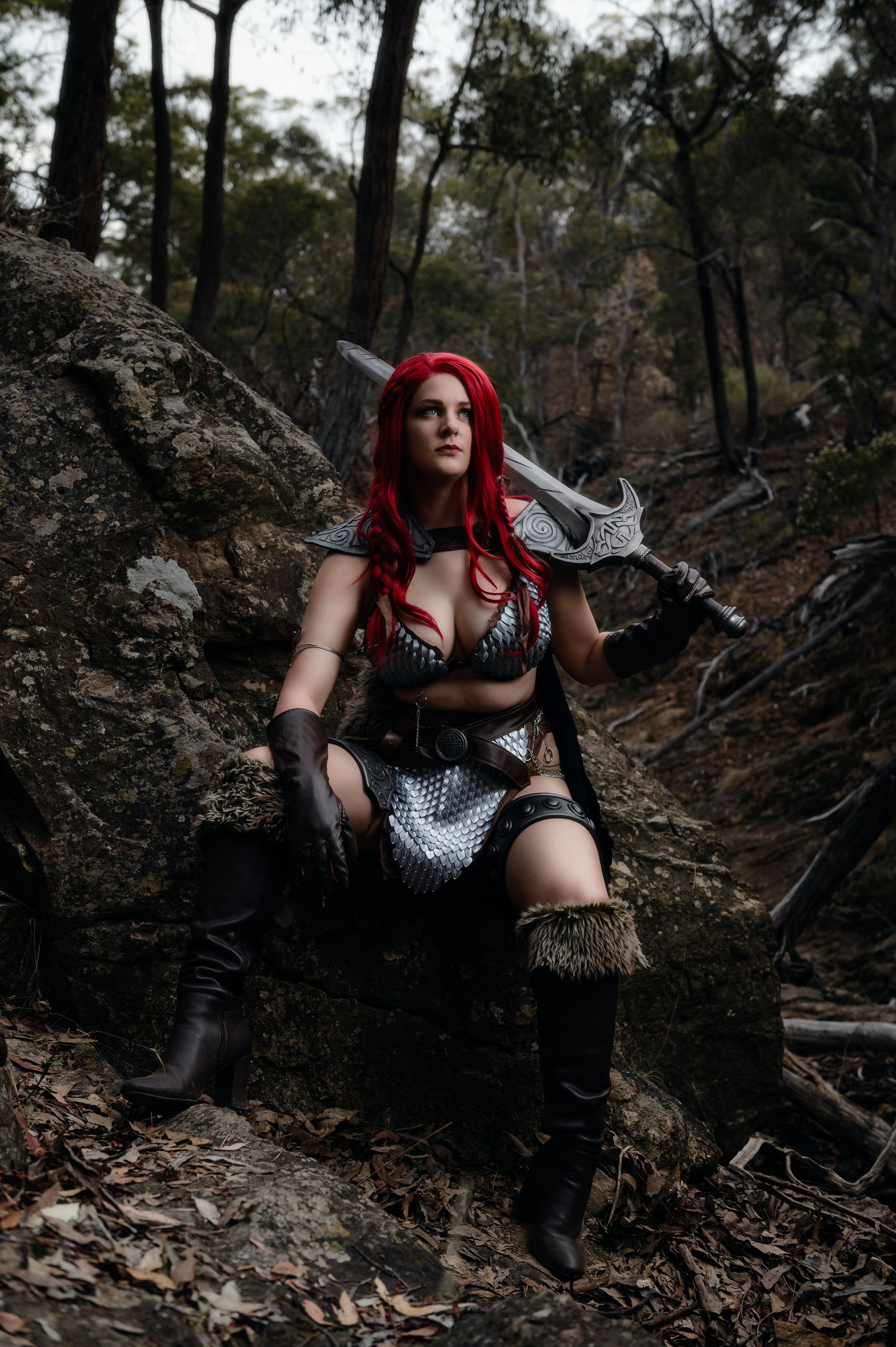Dramatic forest photoshoot featuring cosplay outfit with white and black accents.