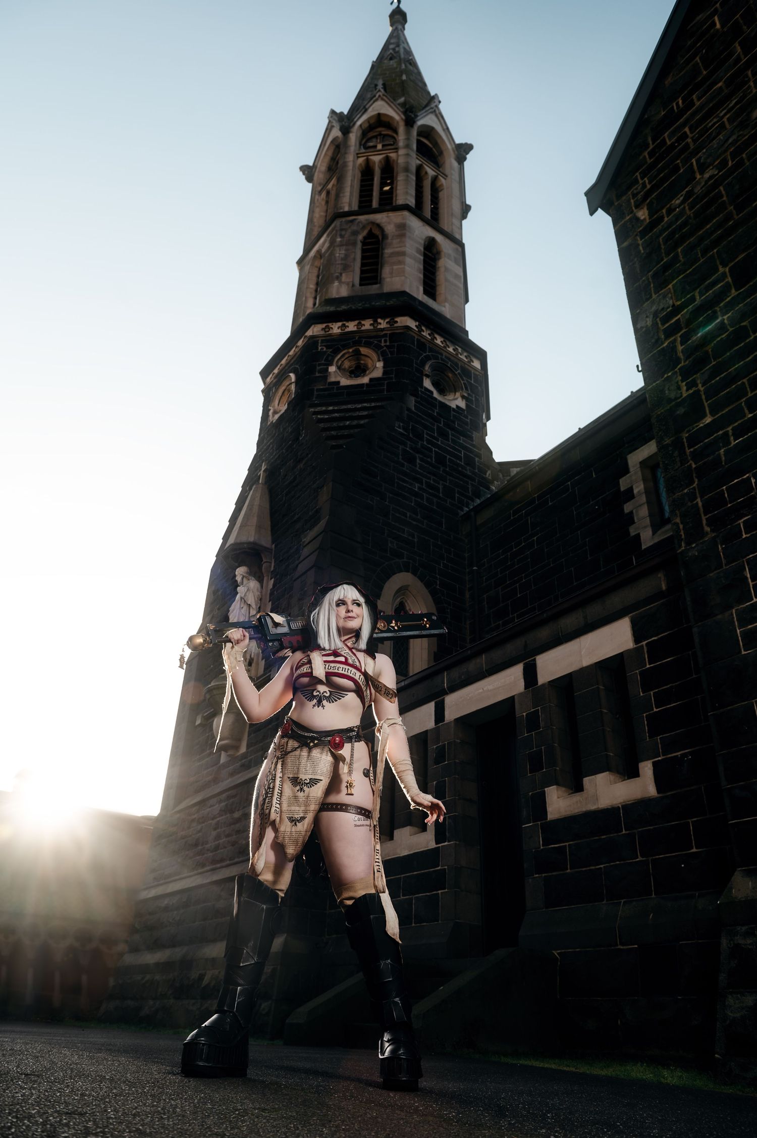 Gothic architecture provides dramatic backdrop for cosplay photography at sunset.
