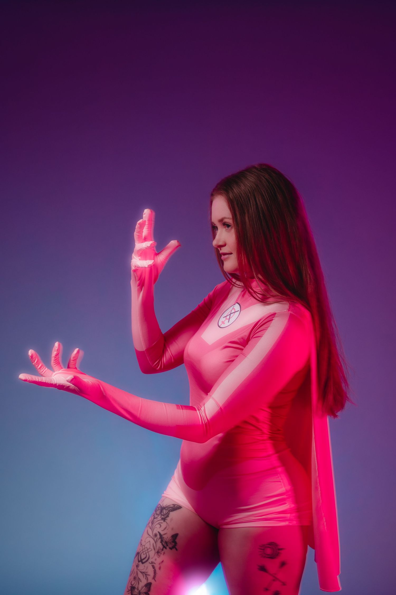 A figure in pink performs an expressive dance sequence against a purple and blue gradient background.