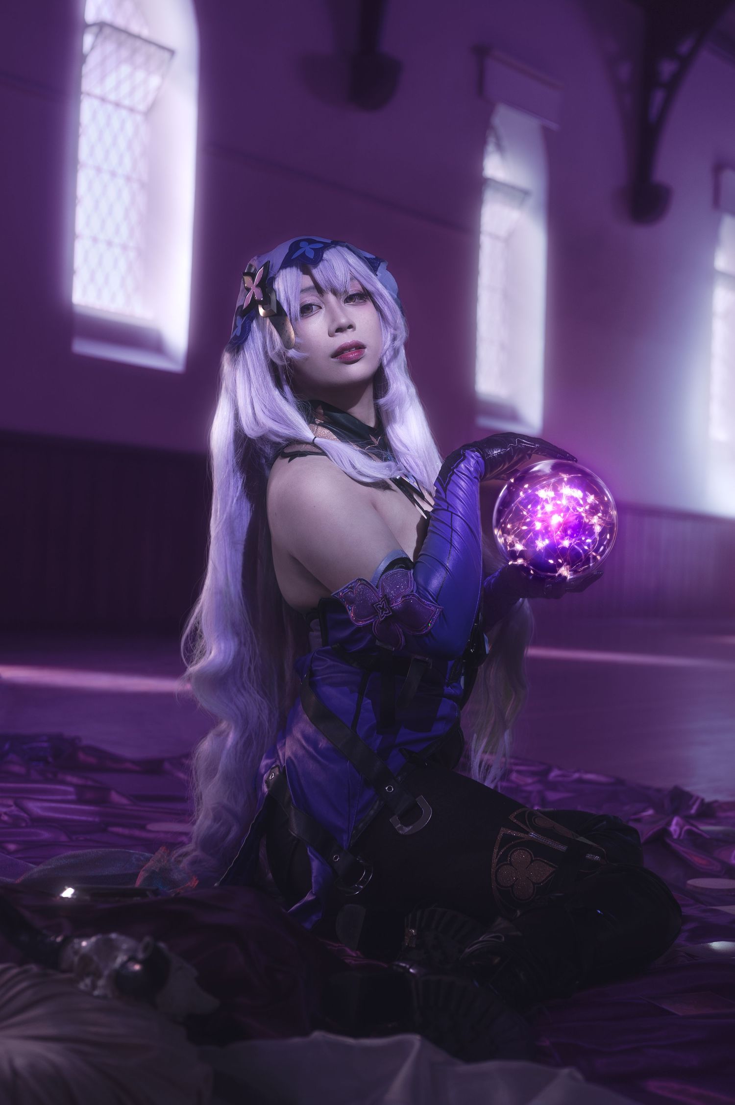 Gothic fantasy scene with figure in black costume amid purple lighting.