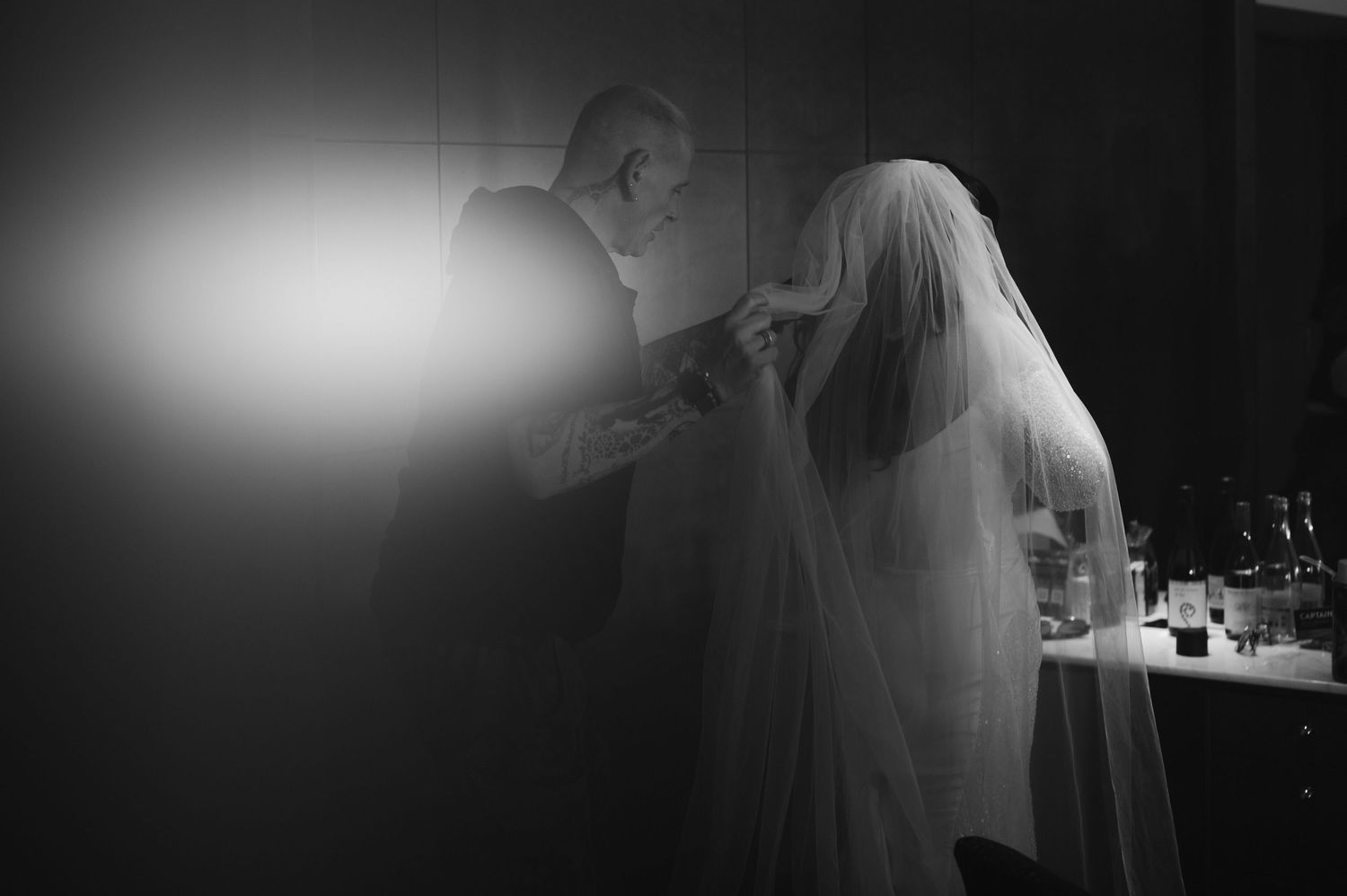 Dramatic black and white silhouette of wedding preparations.