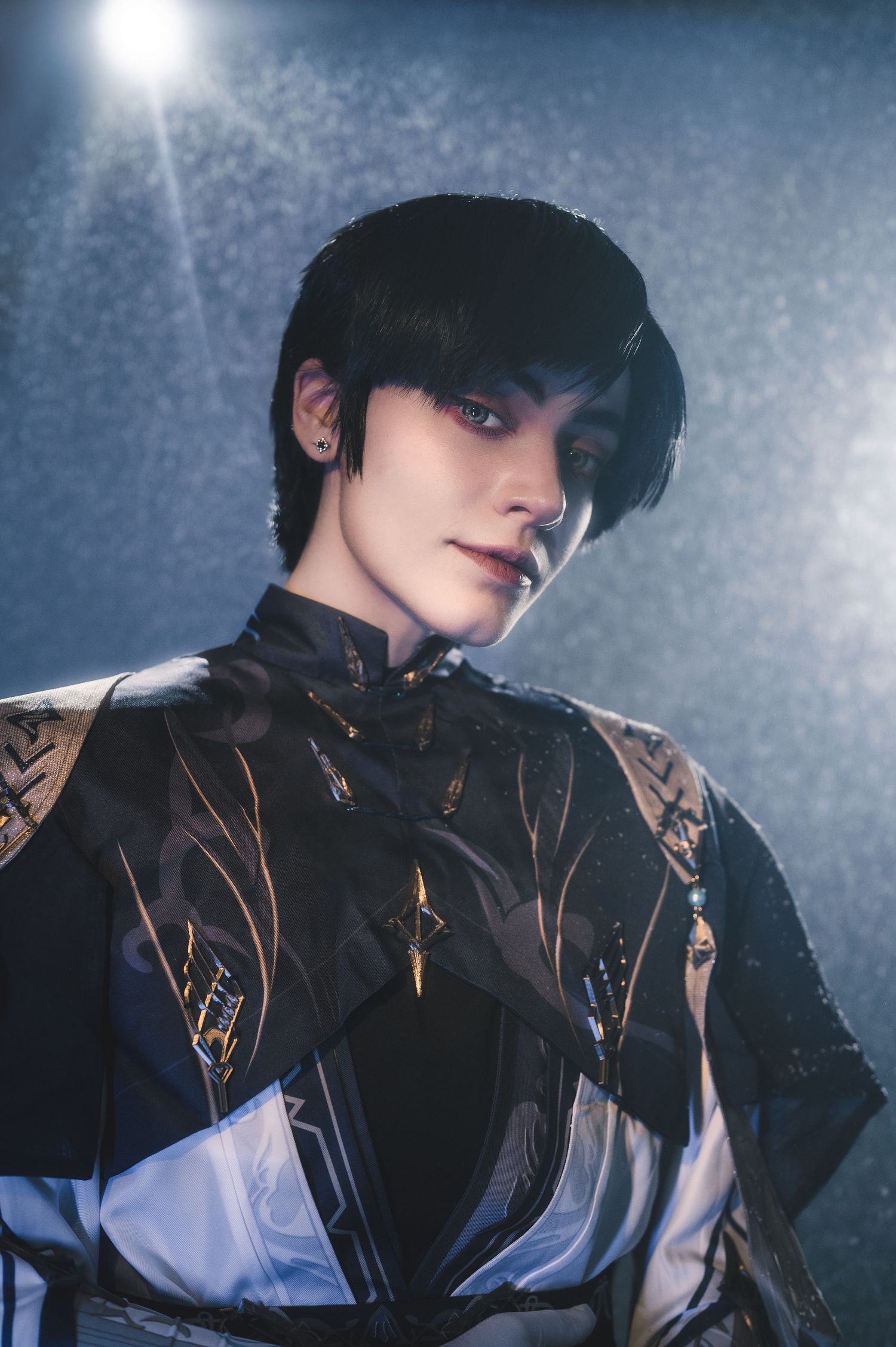 Dramatic fashion portrait featuring black and white clothing with ornate details.