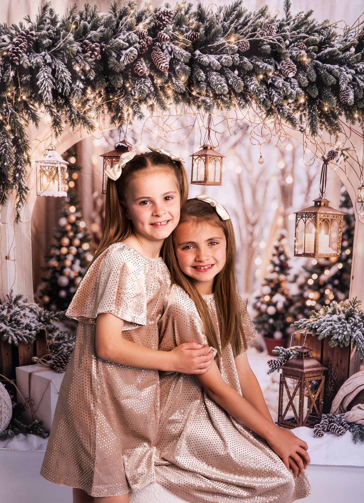 A series of holiday portraits in a winter wonderland setting with sparkly dresses, snow-covered trees and twinkling lights.