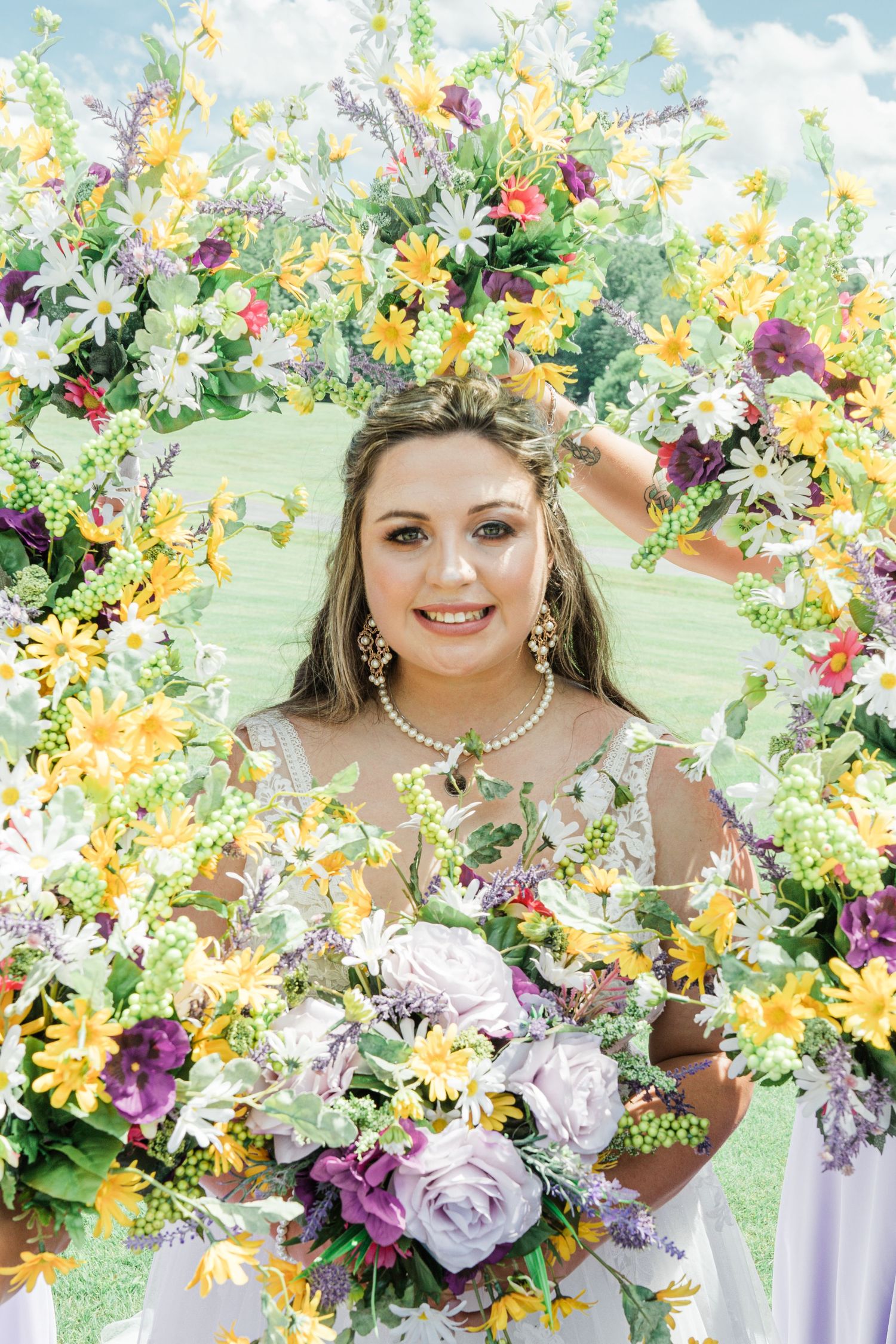 bride in the middle of her bridesmaids' bouquets