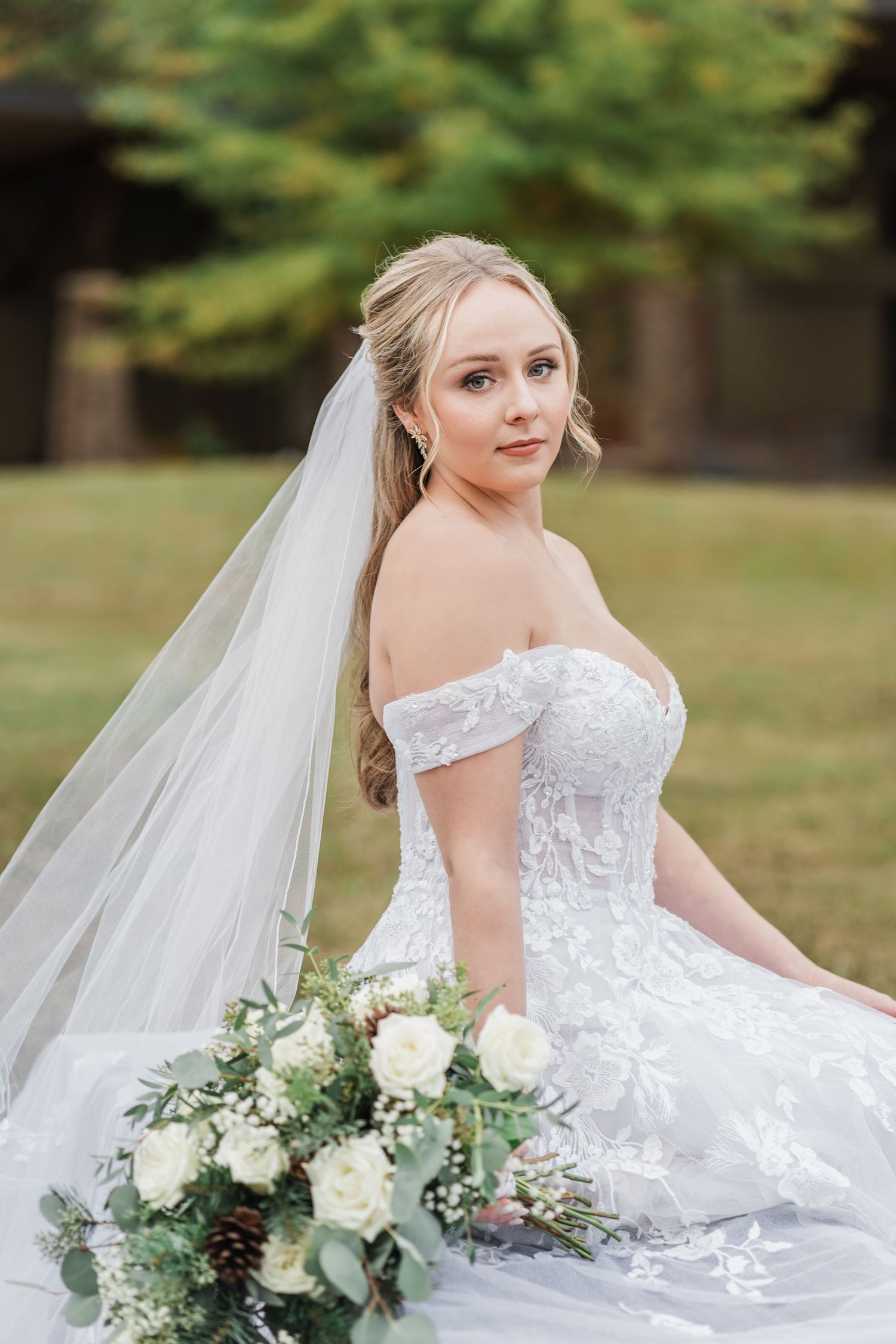 bride wearing her gown and veil in the meadow of camp spearhead