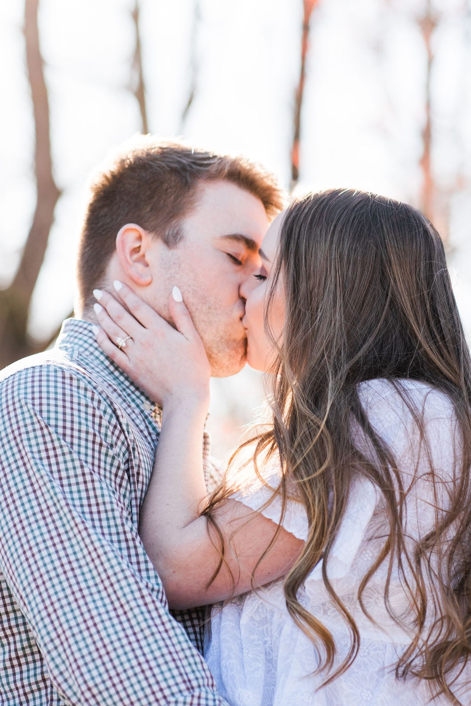 Close up of engaged couple sharing a kiss
