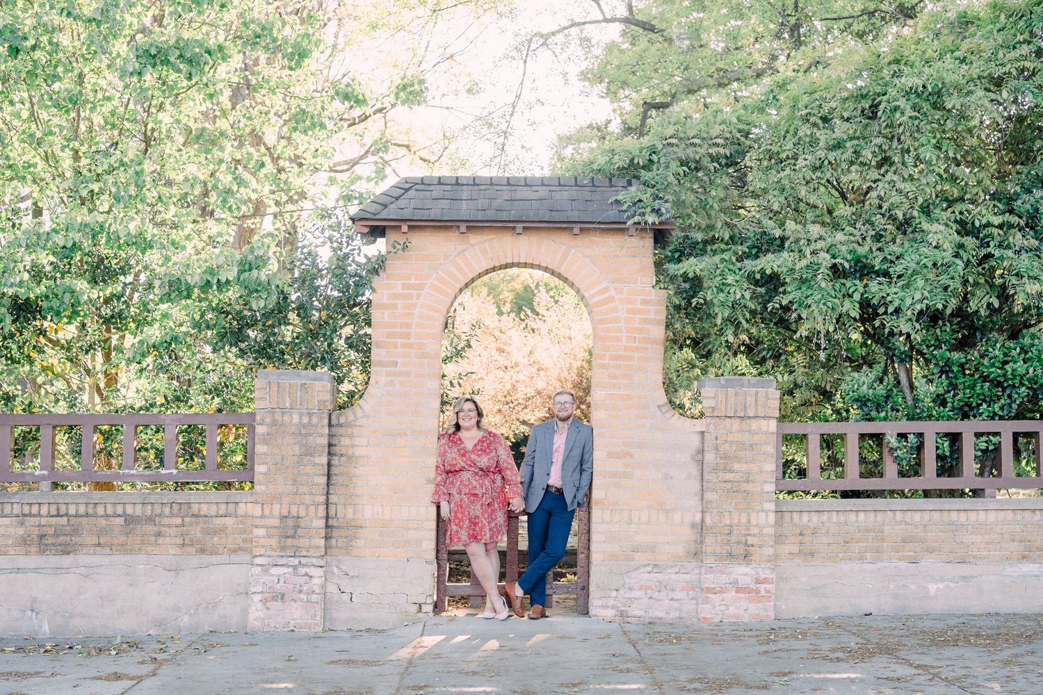 Man and woman leaning against archway in downtown Greer