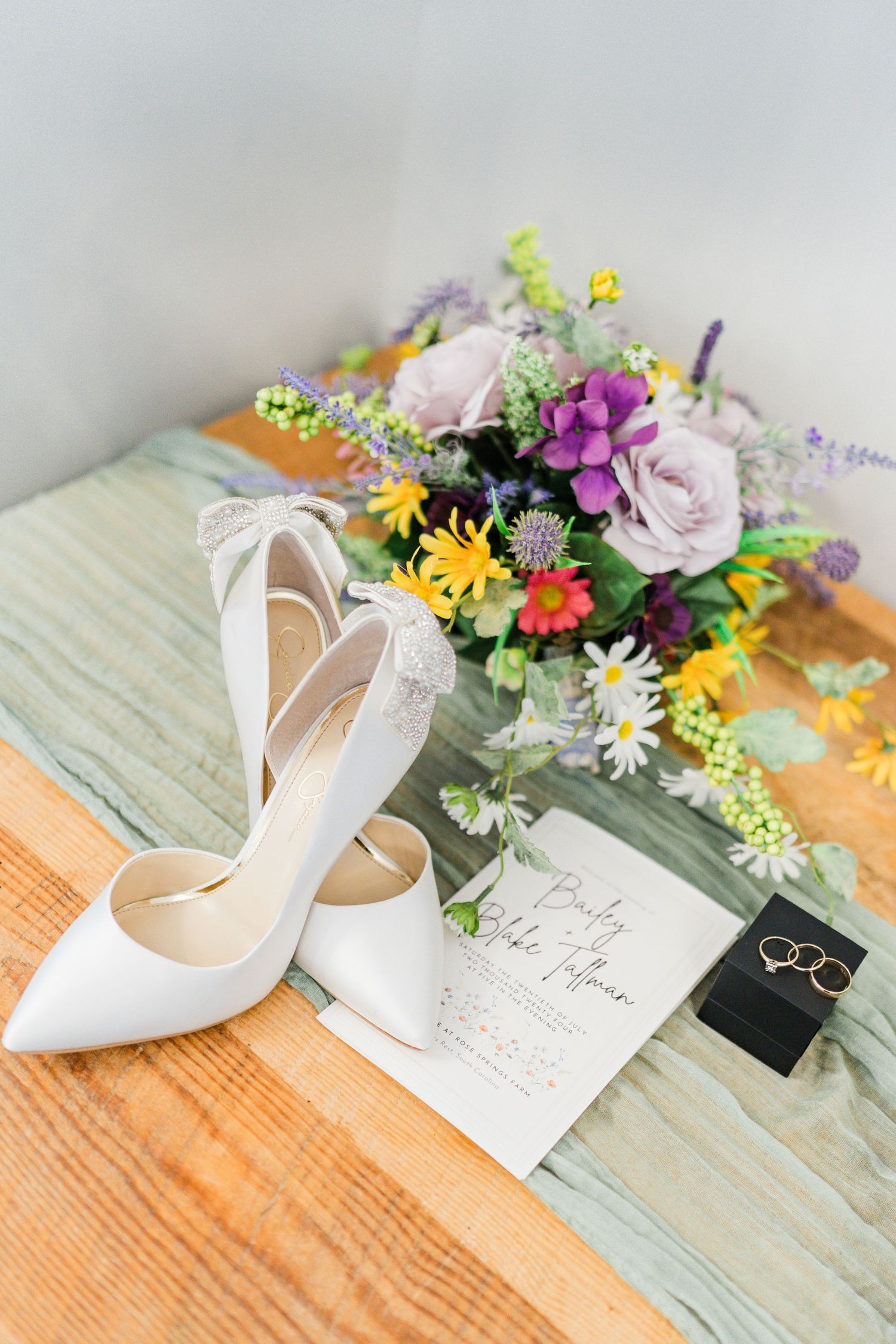 wedding shoes and bouquet and program laying on a table
