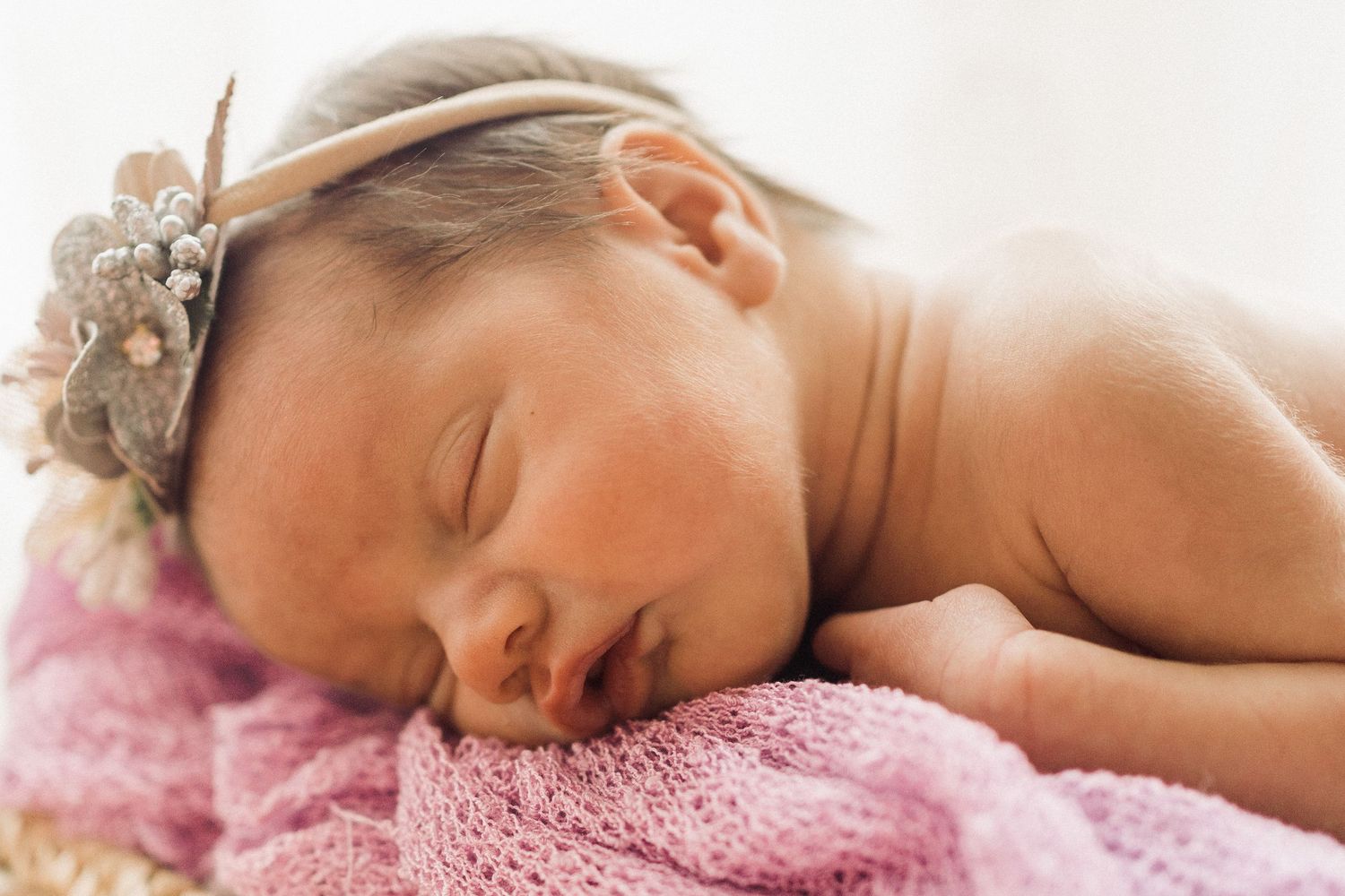 Baby Kat sleeping peacefully during a posed newborn session by Greenville photographer in client's home