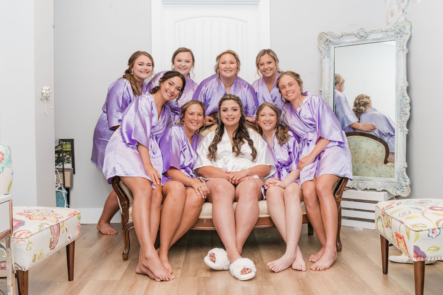 bridesmaids and bride dressed in special wedding day robes getting ready for the wedding