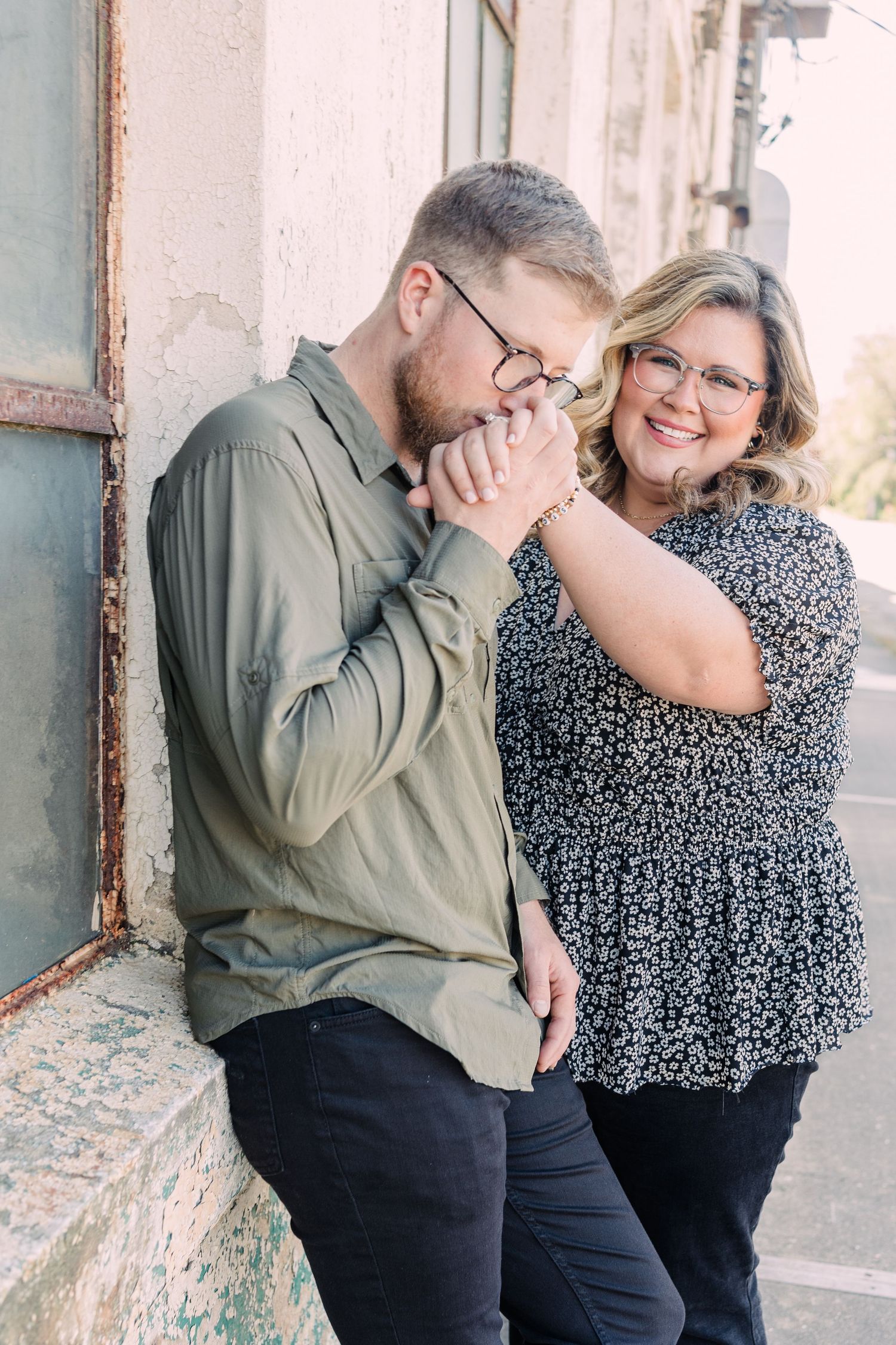 Man kissing woman's hand in front of Taylors Mill