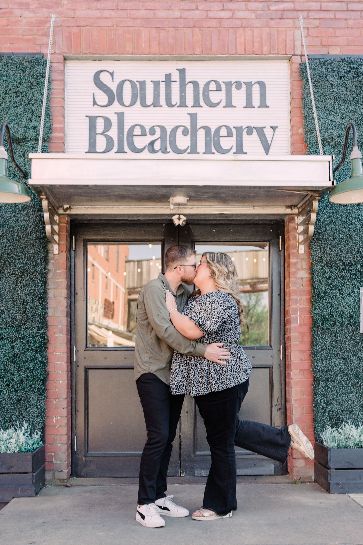 Man and woman kissing outside of southern bleachery