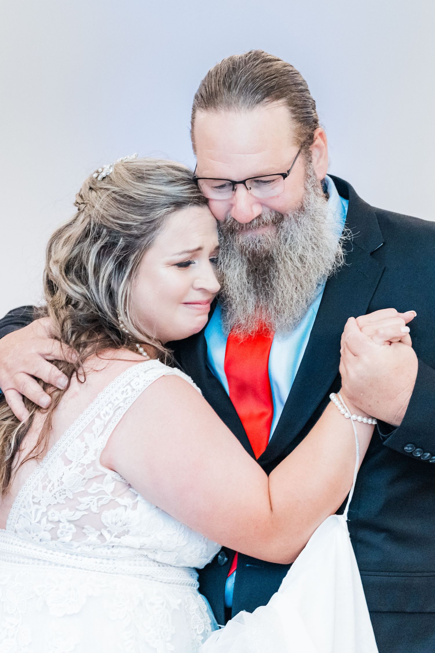 bride and friend dancing together in emotional moment