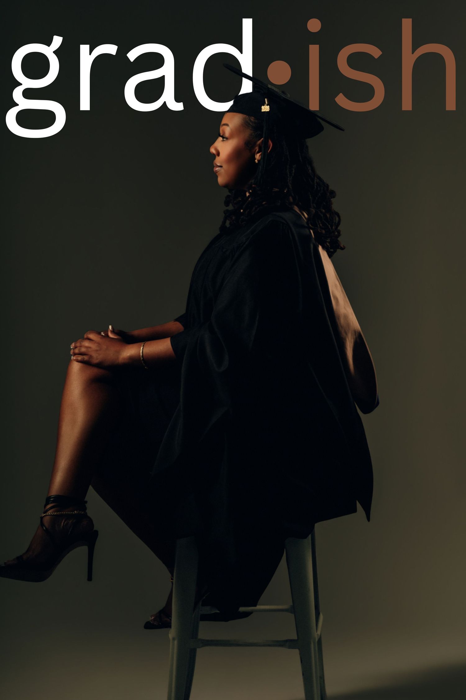 Woman in graduation cap and gown sits elegantly on stool beside grad-ish text overlay.