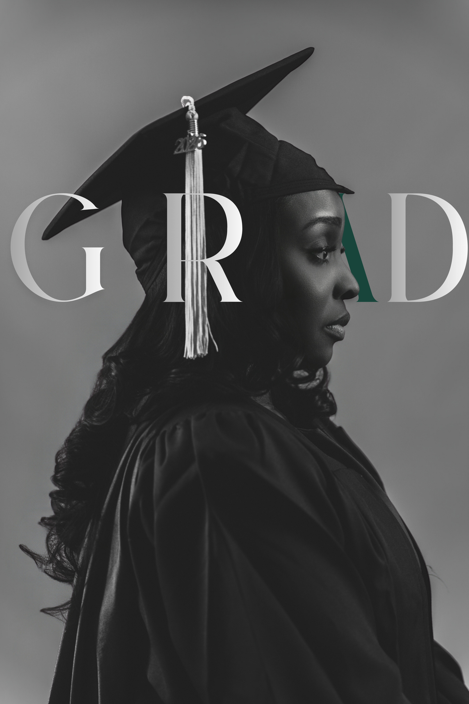 Black woman in graduation cap and gown in black and white GRAD portrait photo.