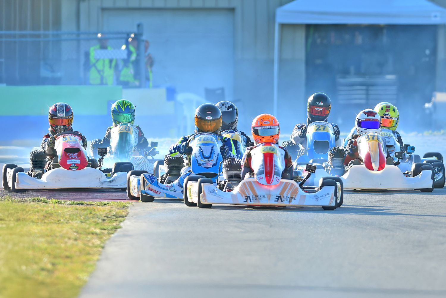 Professional gokart drivers racing on a track