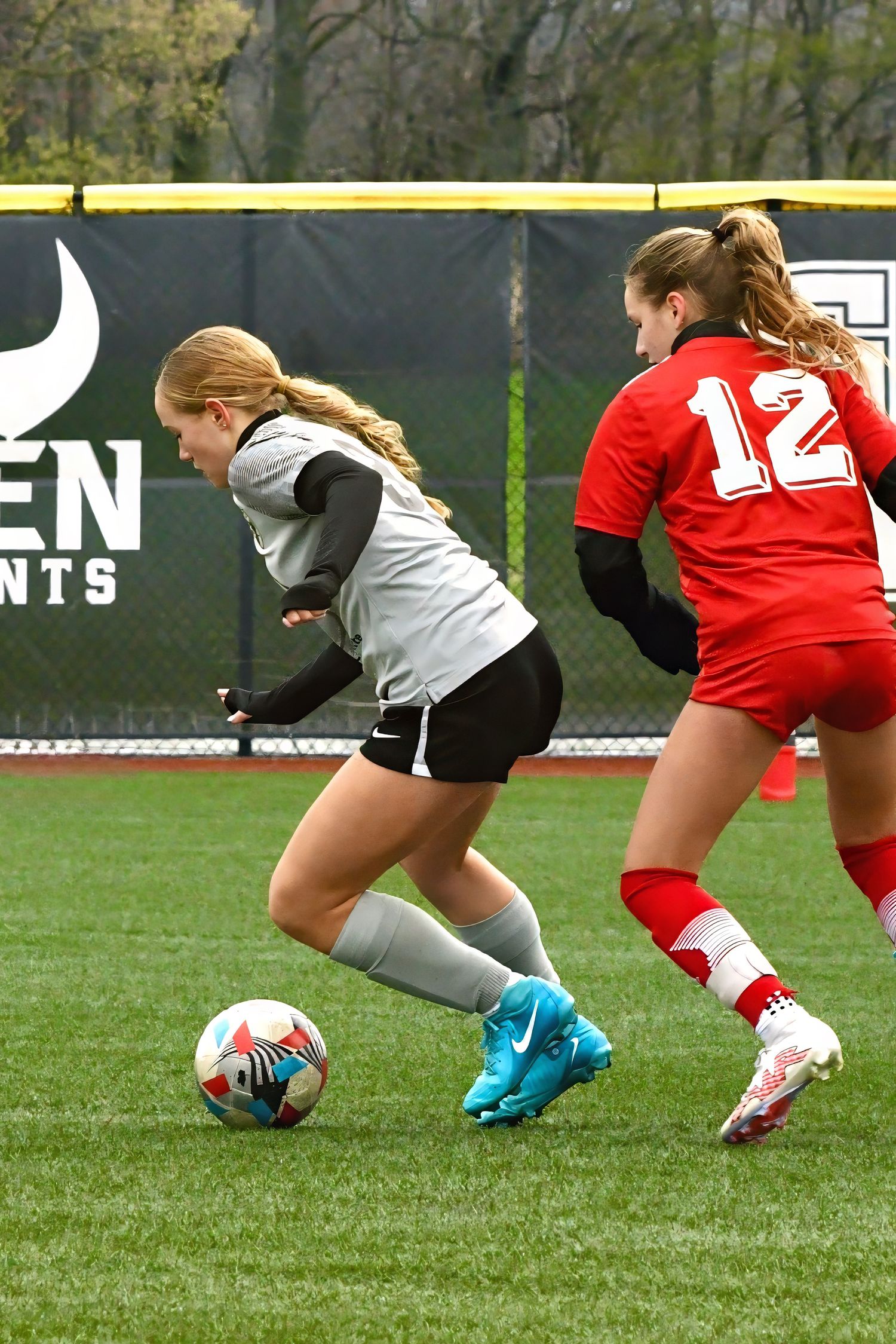 Female soccer players dribbling