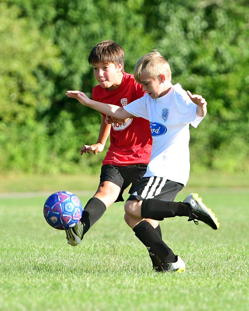Two athletes playing soccer