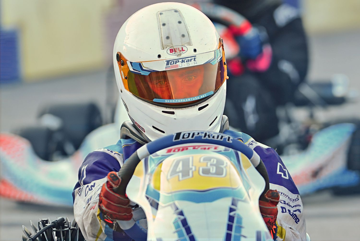 Professional gokart driver racing on a track
