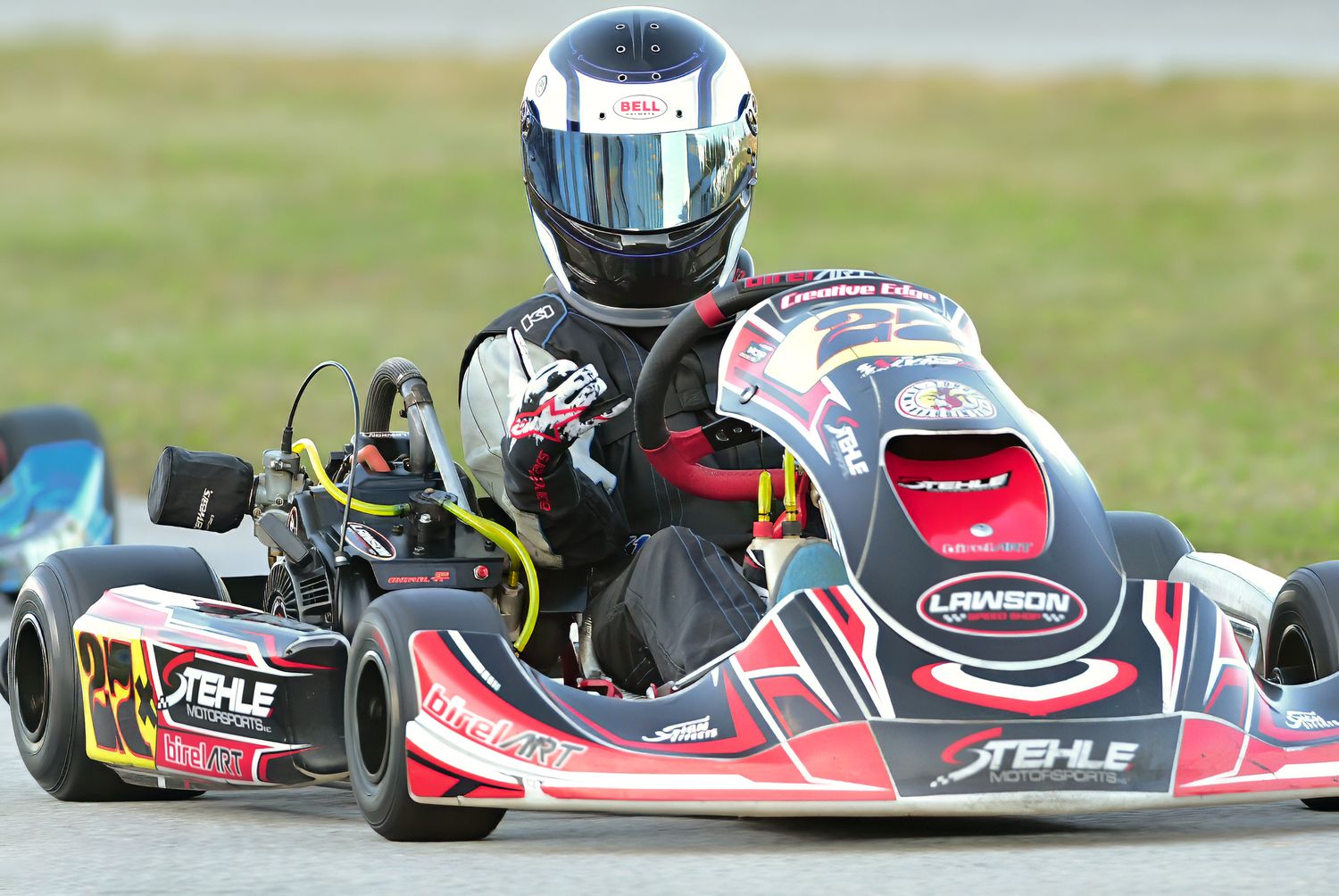 Professional gokart driver in car on track