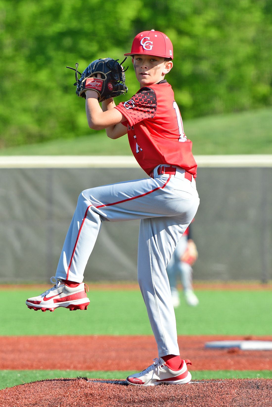 Baseball player in red and grey uniform on the pitching mound
