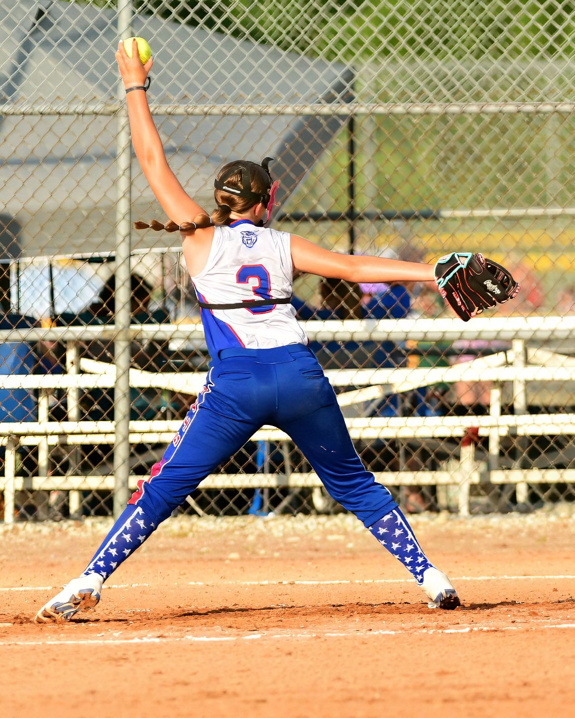 Softball player about to pitch the ball