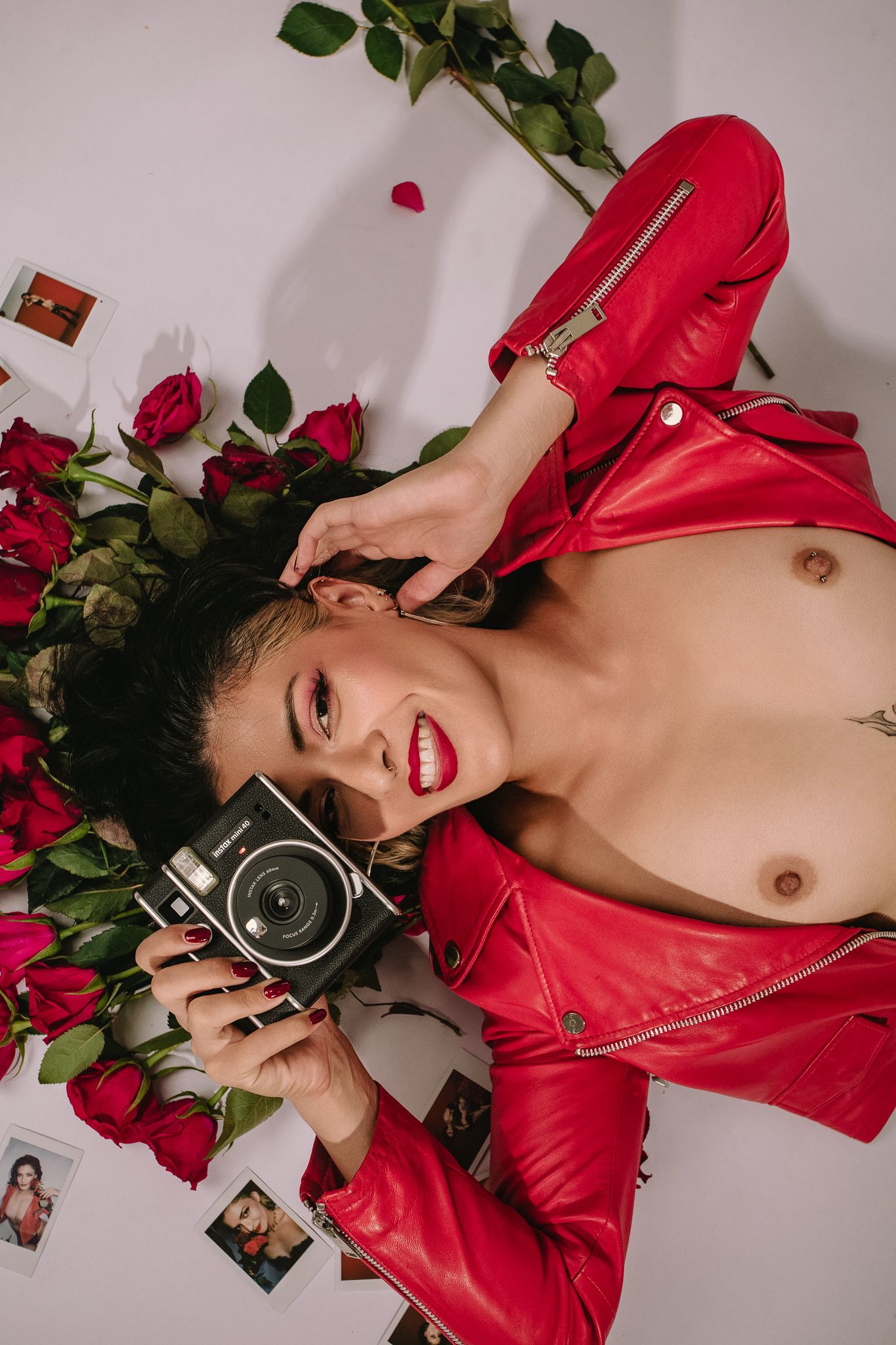 Top view photo collage showing red jacket, roses, and vintage camera arranged on white background.