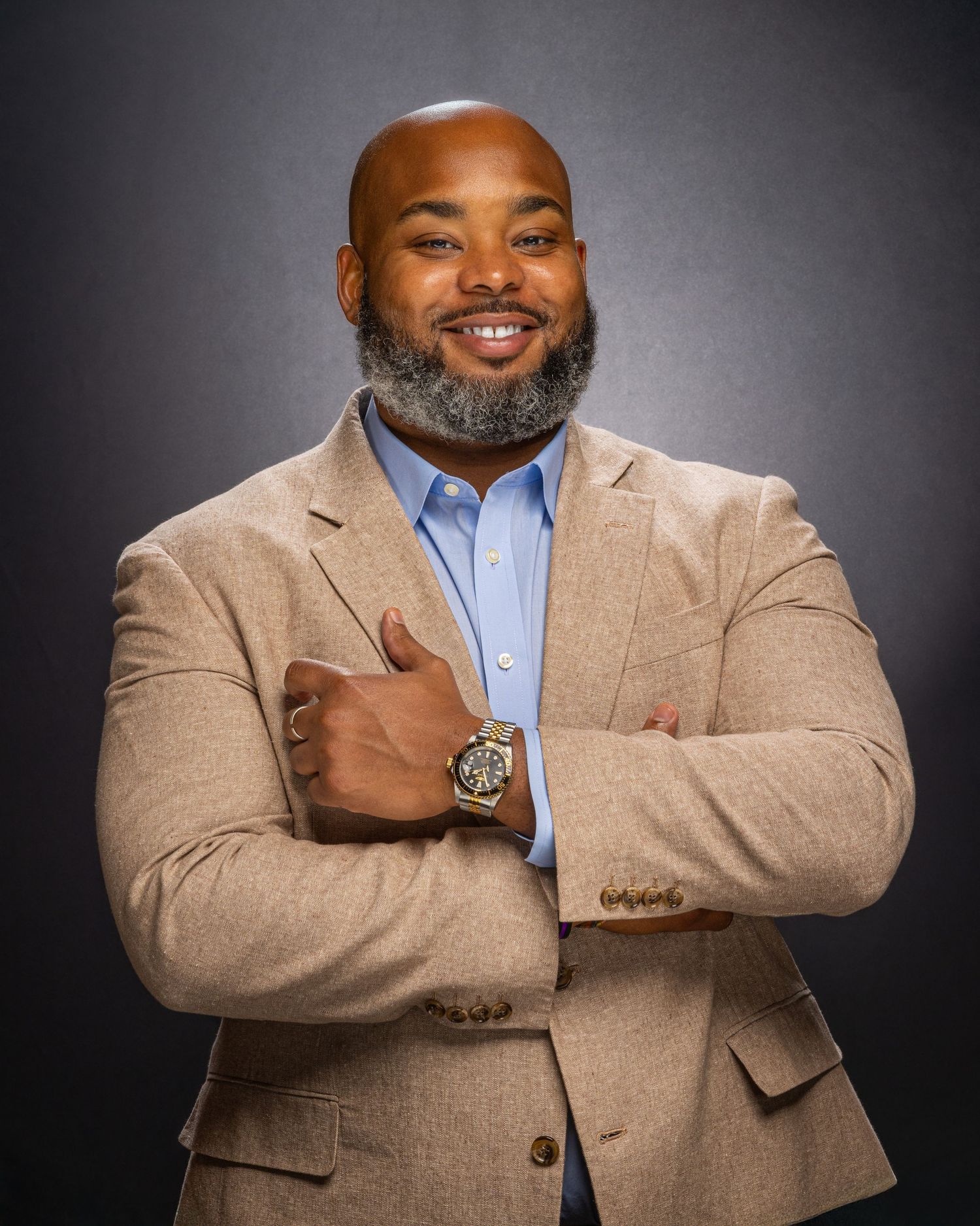 Professional portraits showing someone in beige blazer and light blue shirt against grey backdrop.