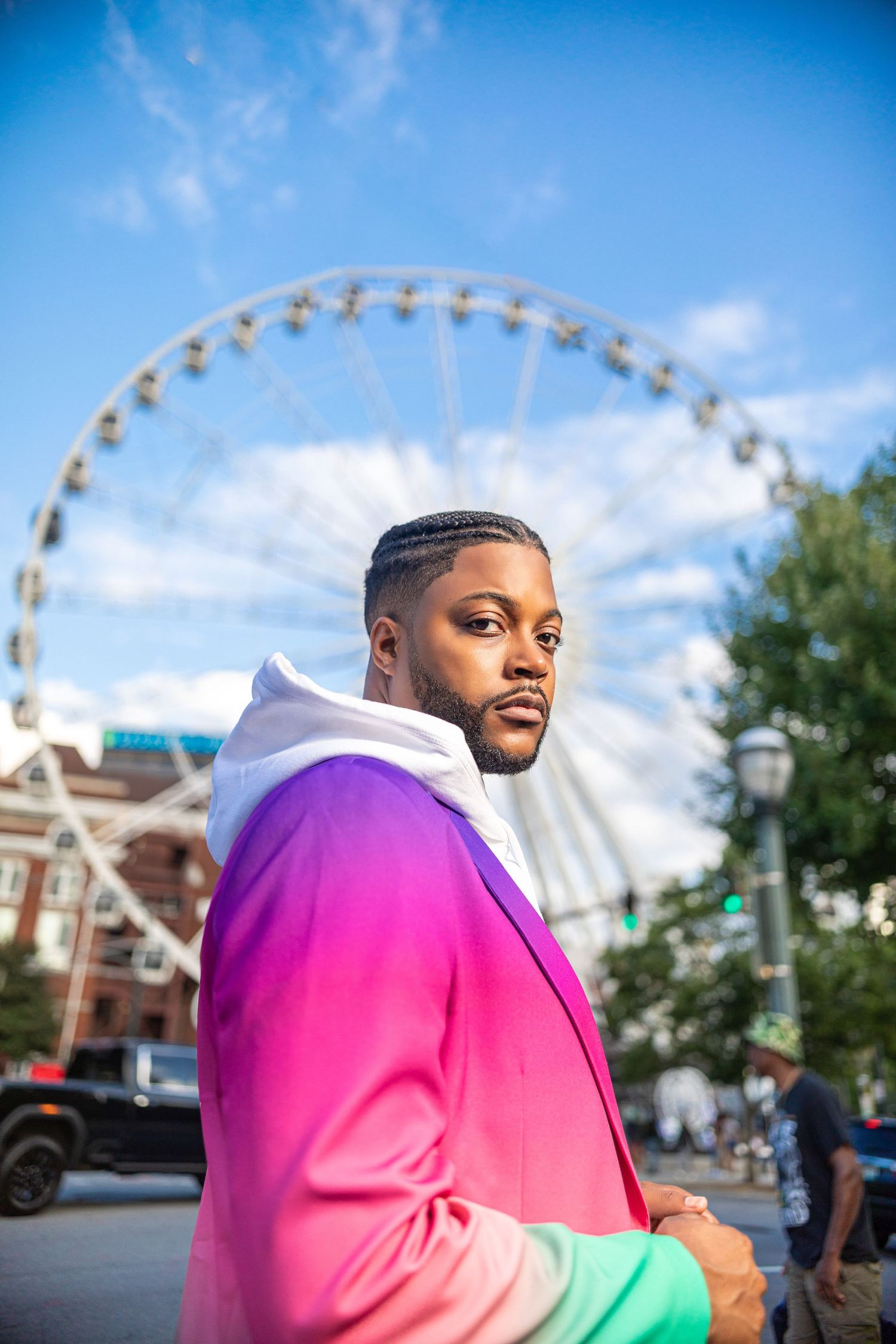 Colorful casual street fashion photography with a ferris wheel in the background on a bright sunny day.
