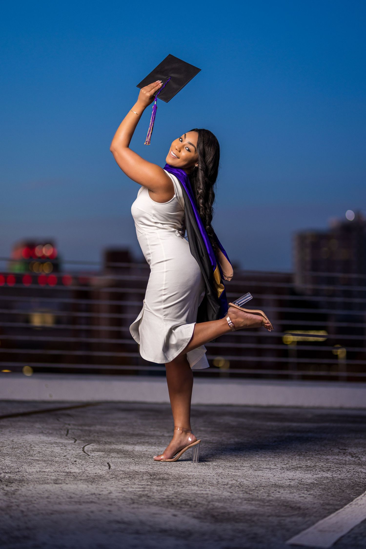 Dynamic dance poses captured on a rooftop with blue sky background.