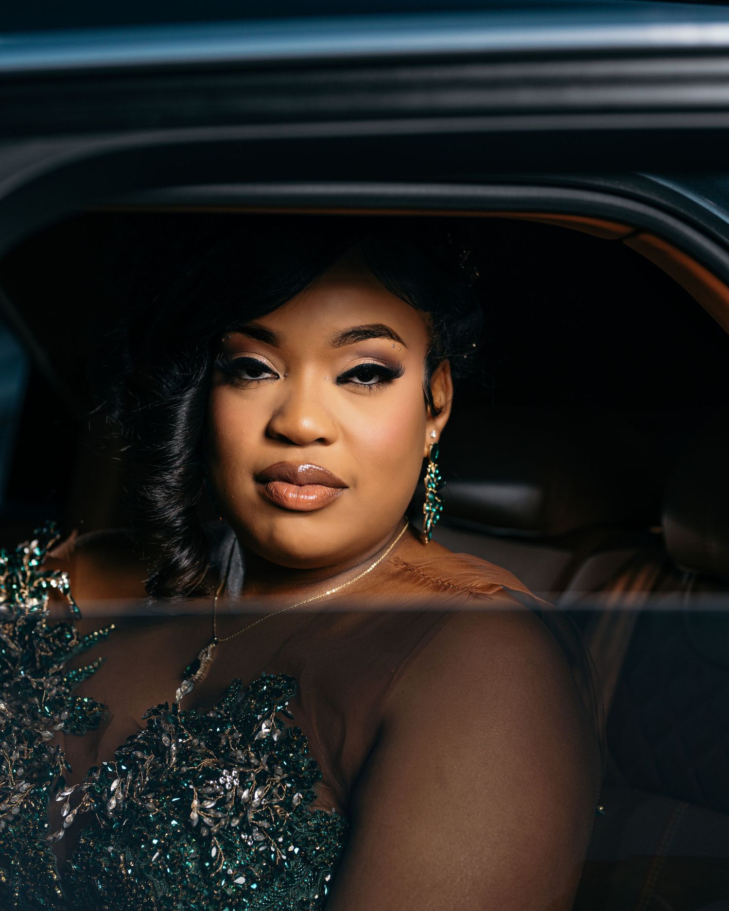 Elegant portrait series of woman in sparkly green dress inside luxury car.