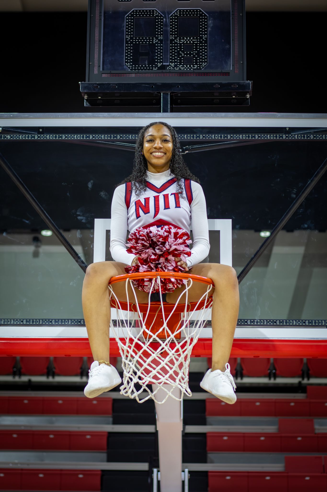 Cheerleader on basketball rim