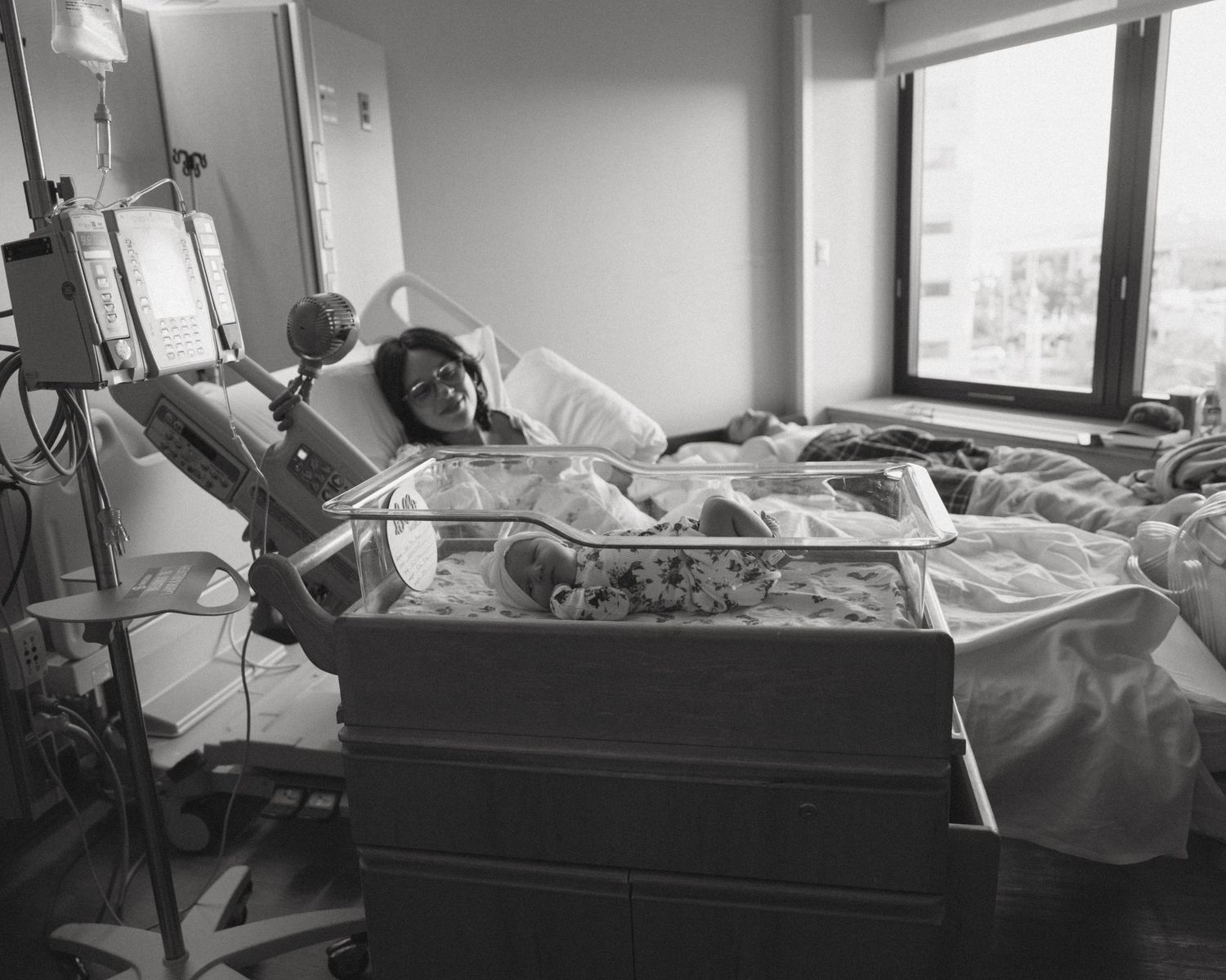 A series of black and white photos showing someone resting in a hospital bed.