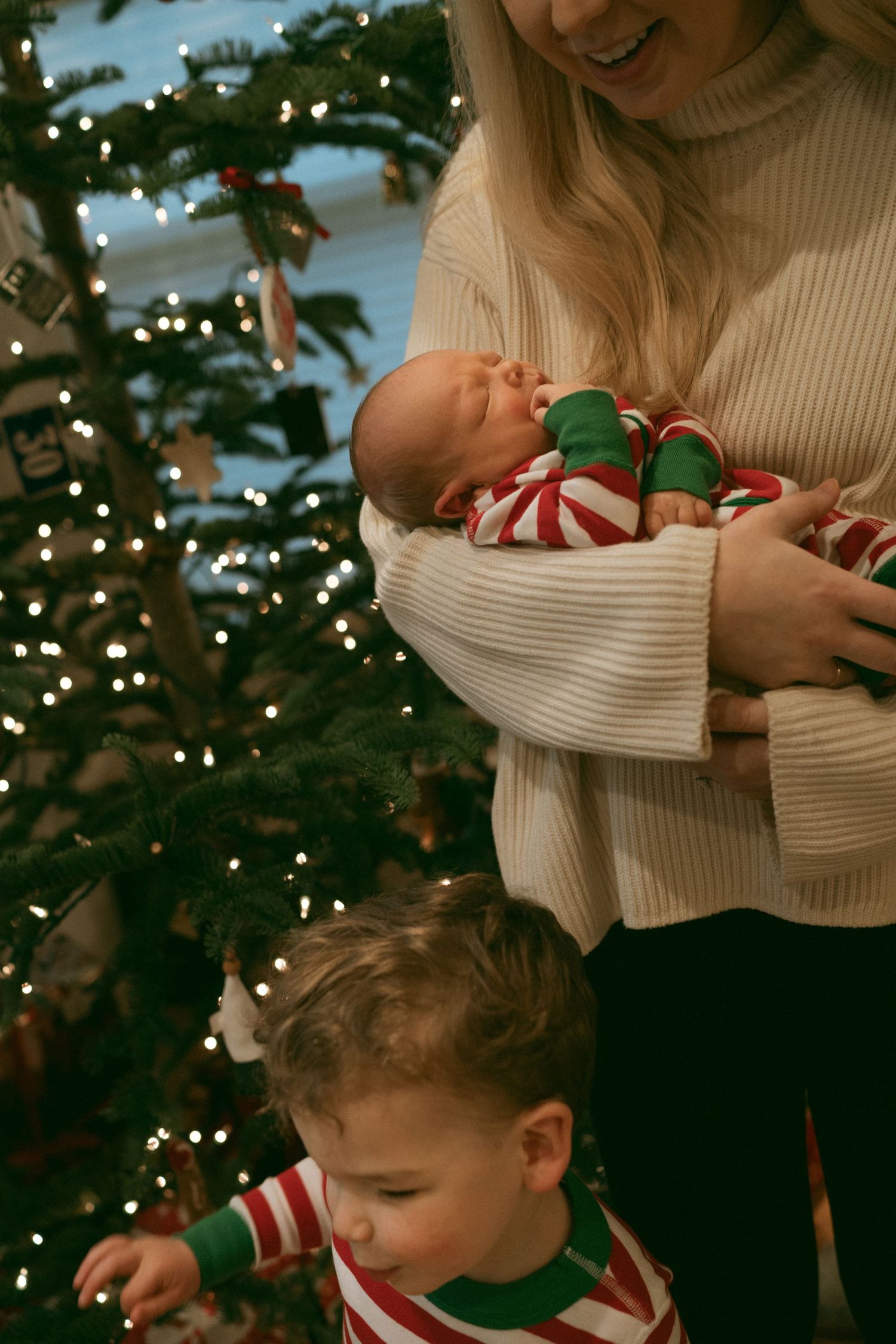 Warm holiday moments captured near a Christmas tree with festive decorations.