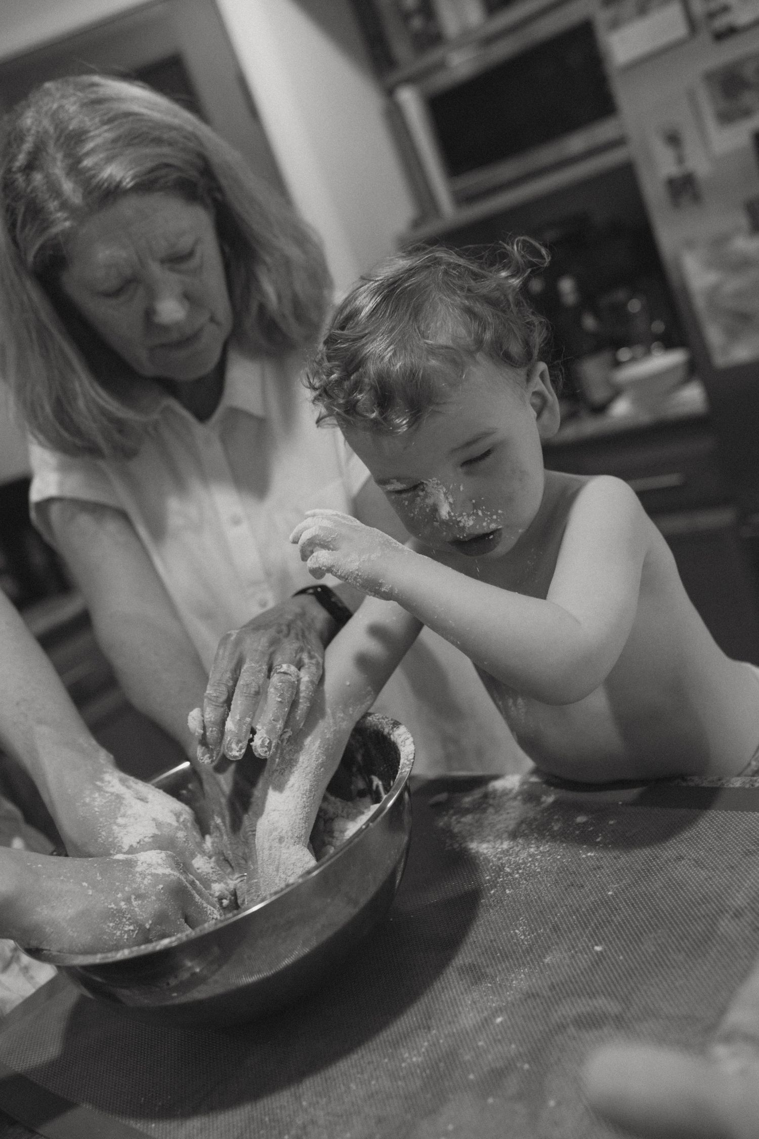 A black and white sequence showing a person eating pie directly from a plate without utensils in a messy manner.