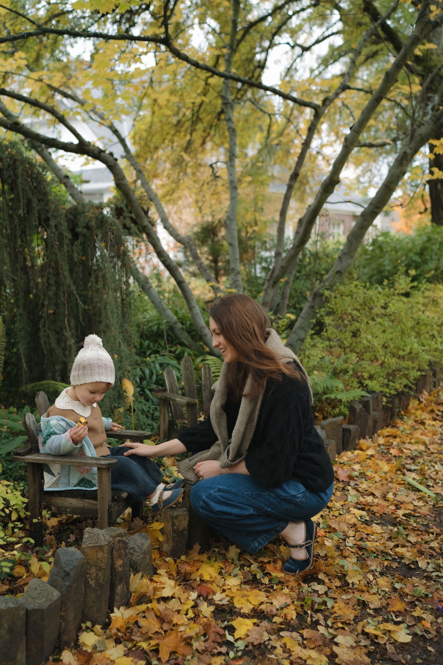 Autumn scene with fallen leaves showing quiet moments on a wooden bench in a garden.