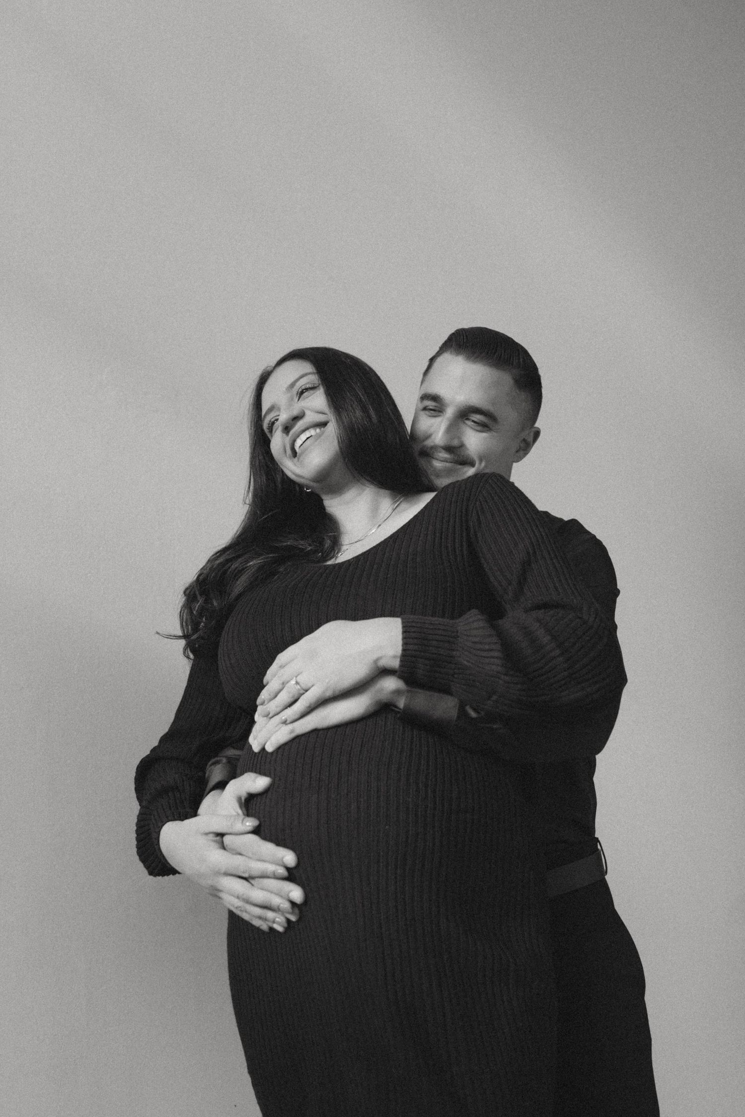Black and white photo series showing a couple embracing and dancing together in an intimate moment.