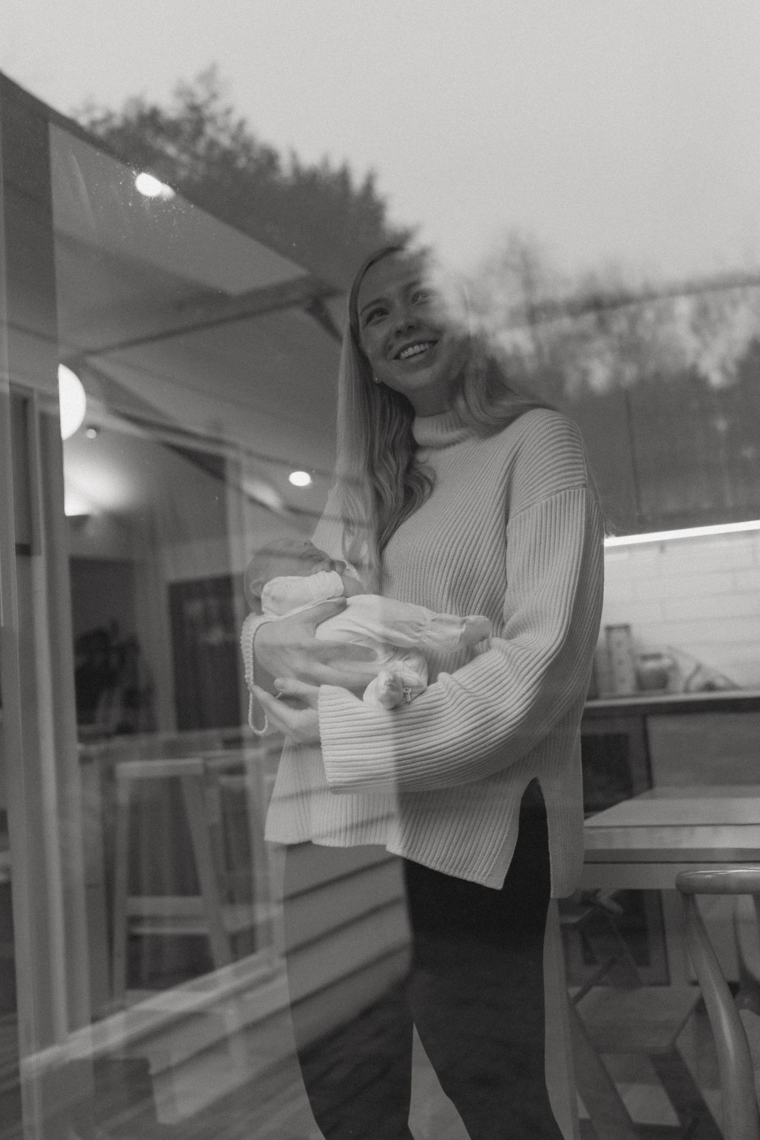 Series of window reflections showing someone in a striped sweater by glass panes.