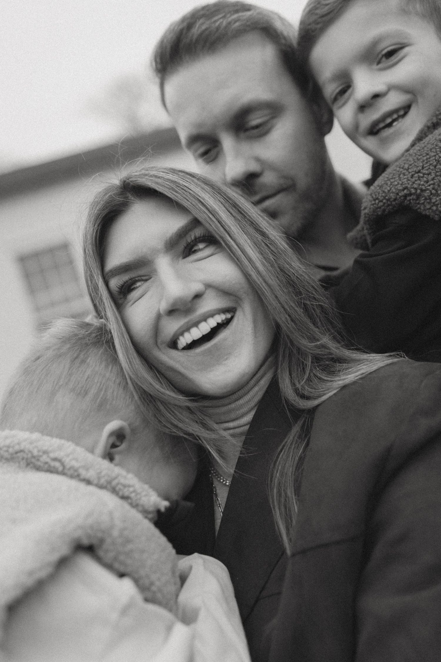 Black and white photo series showing joyful winter moments outdoors.