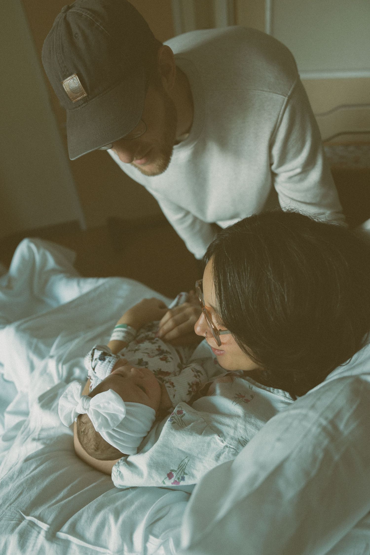 A sequence of intimate hospital bedside moments captured in soft lighting.
