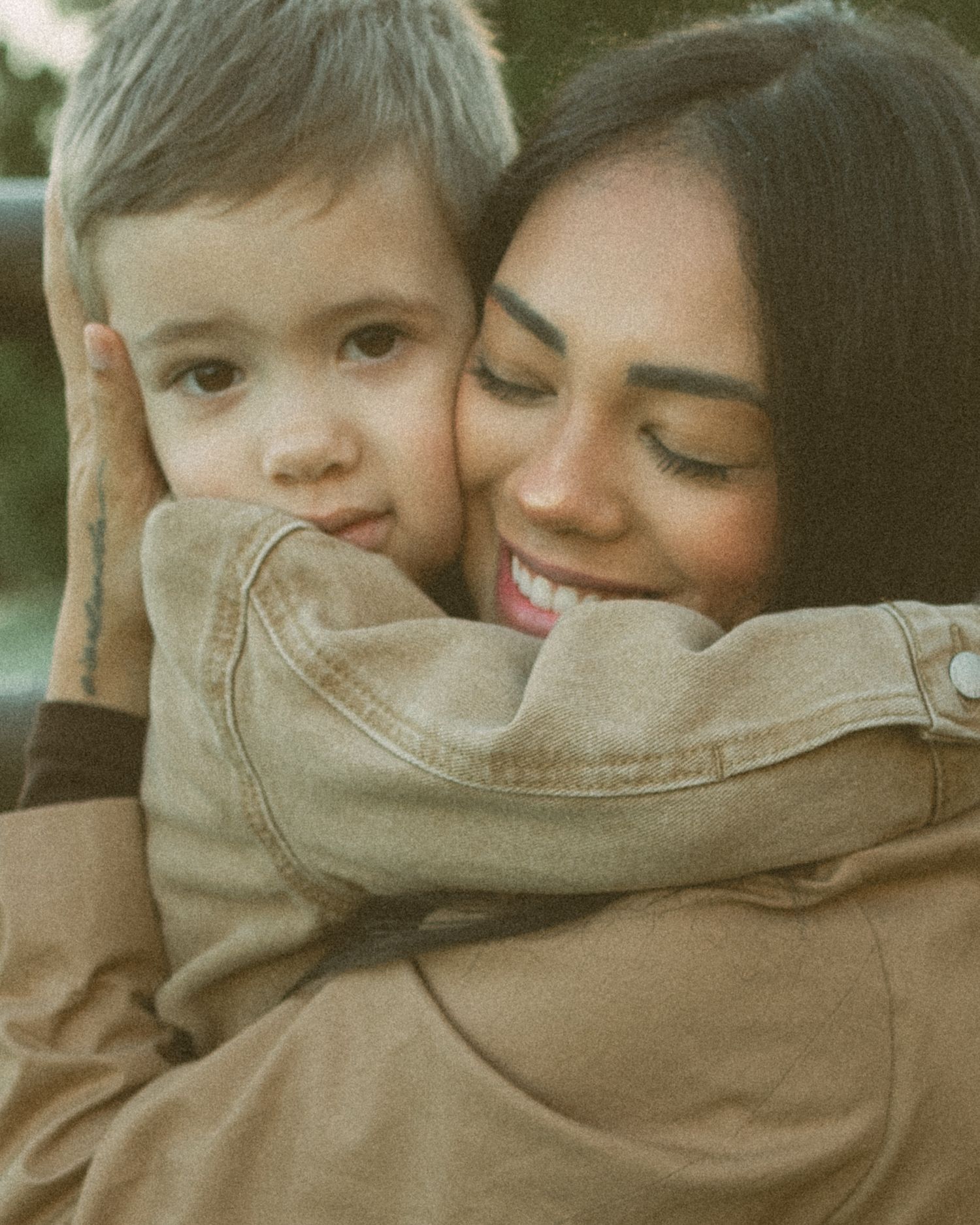 A series of intimate close-up shots showing tender moments between a parent and child in warm, muted tones.