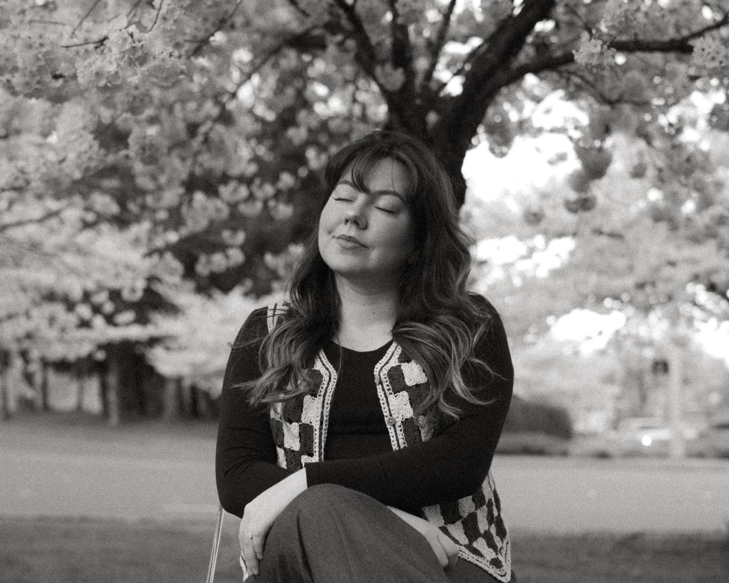 Black and white outdoor portrait series in a natural park setting.