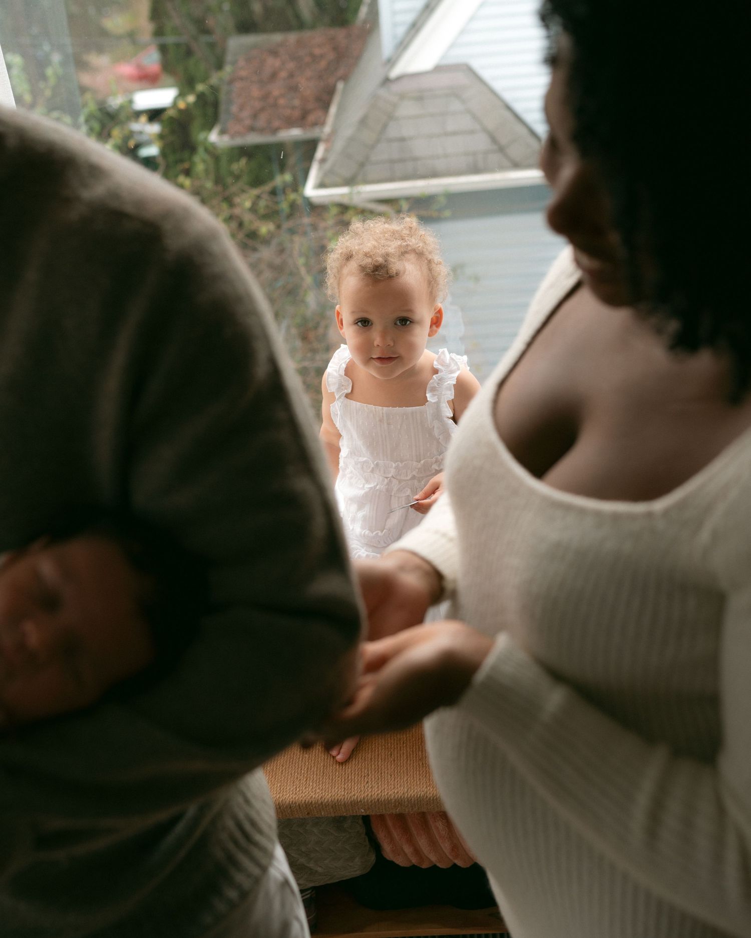 A series of candid photos showing a tender moment between two people in warm lighting.