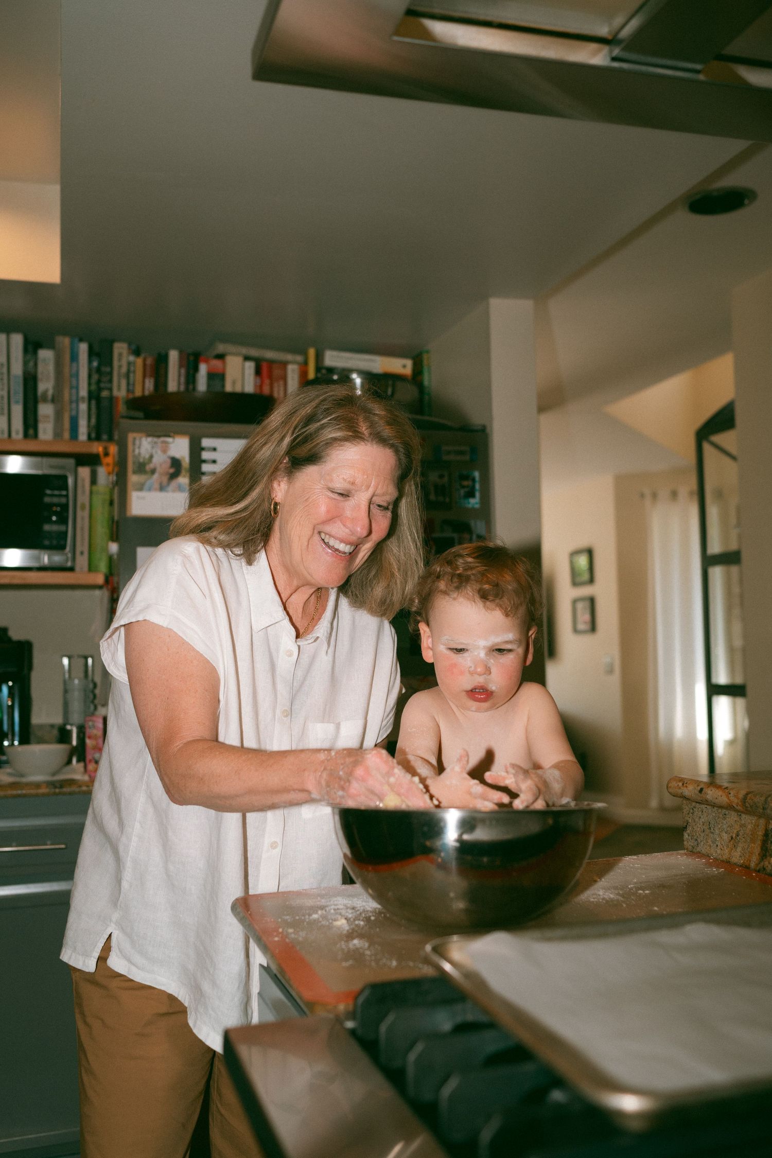A heartwarming kitchen scene of baking together with a mixing bowl on the counter.