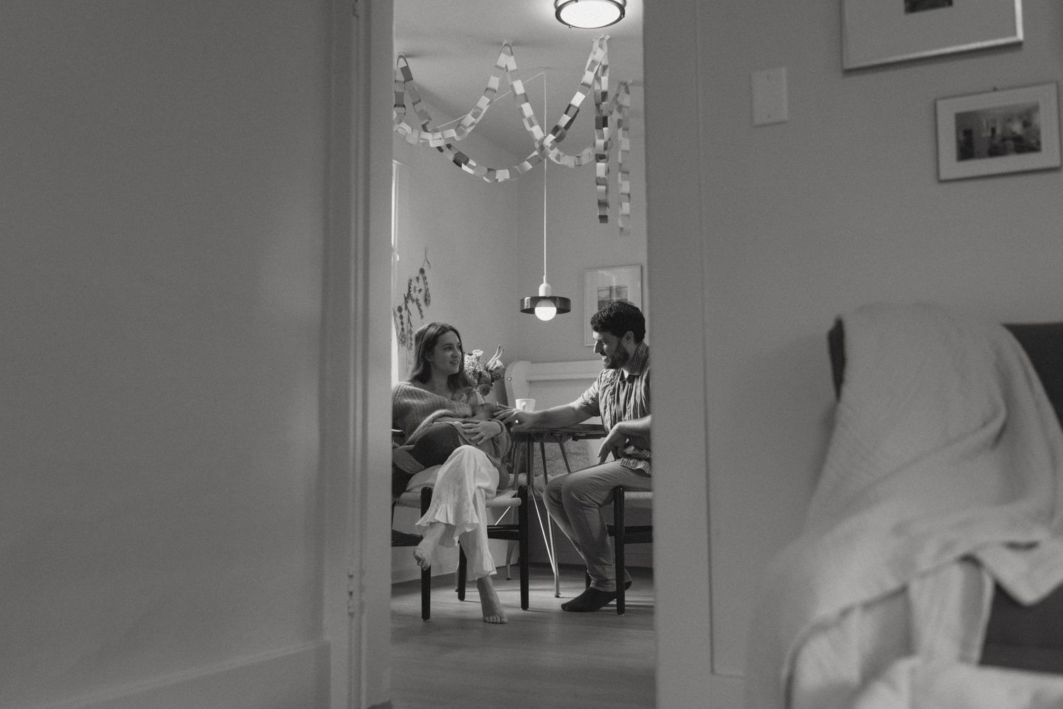 Sequence of black and white photographs showing interior moments in a room with overhead lighting.