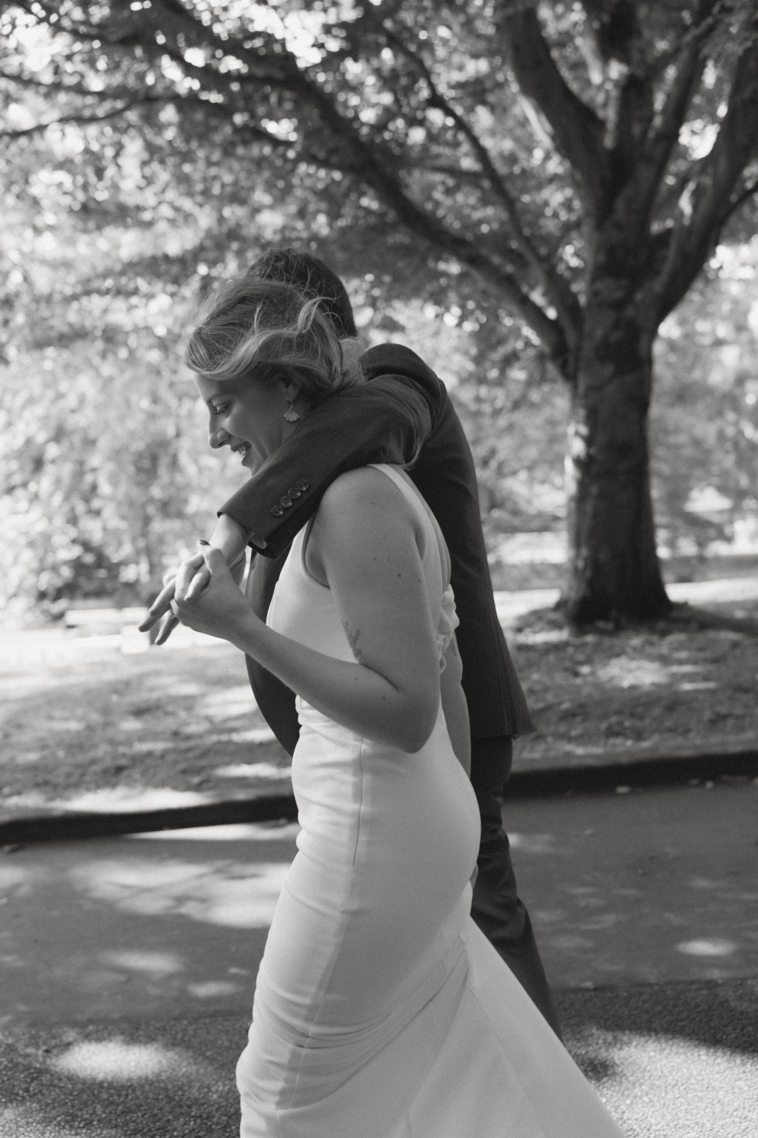 Black and white sequence capturing a romantic dance moment in a park setting under trees.