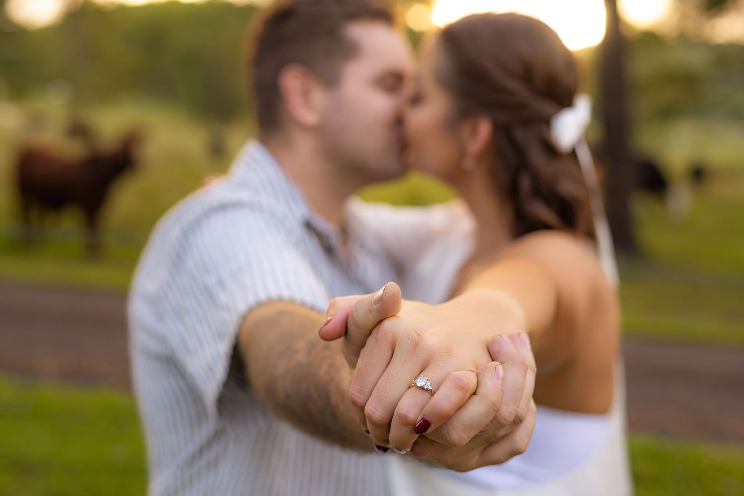 Wedding couple sharing an intimate moment at sunset with bokeh lighting.